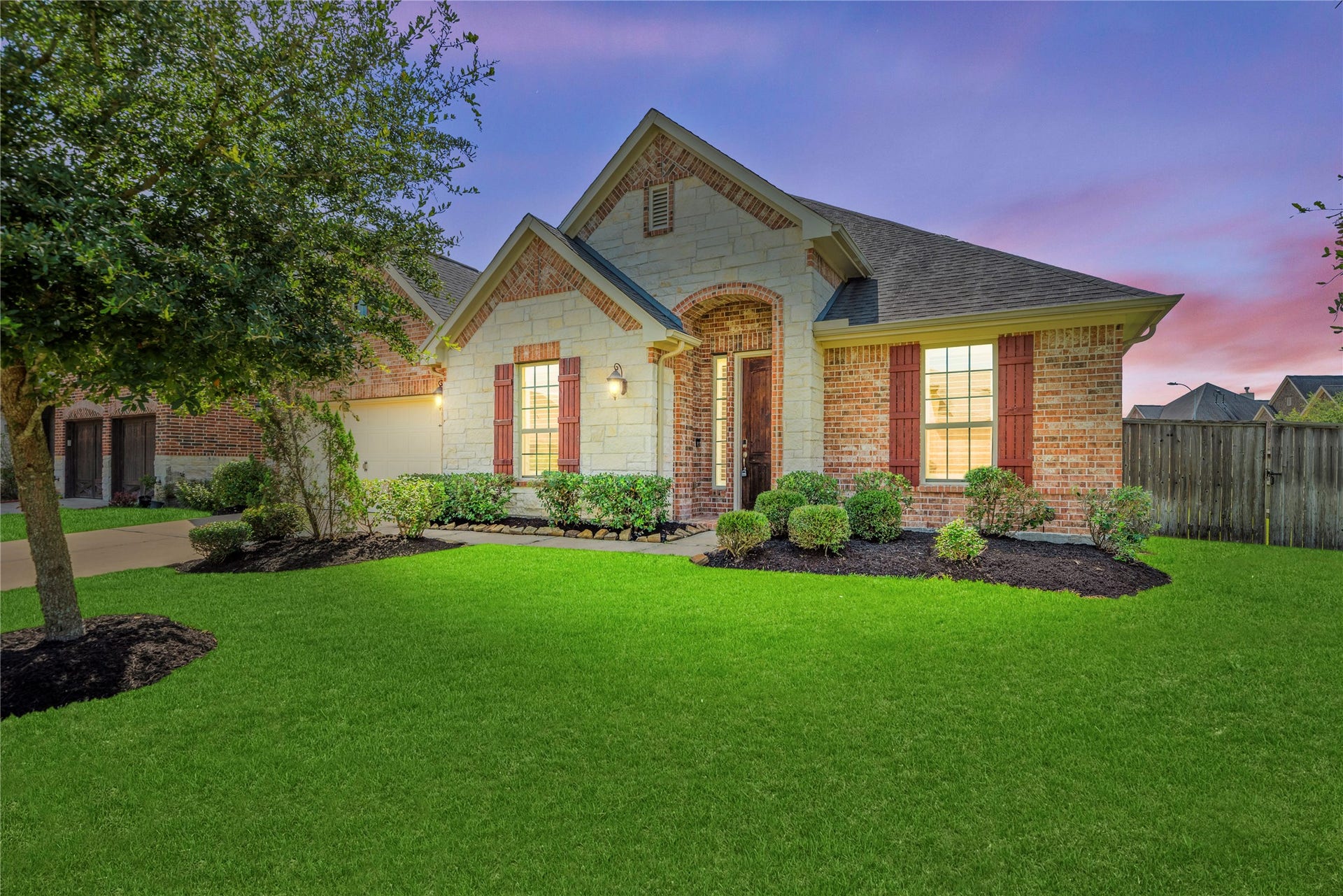 19851 Quarry Stone Lane, Richmond, TX 77407 This home shines at twilight stone, brick, and a glowing entry on a rare oversized corner lot