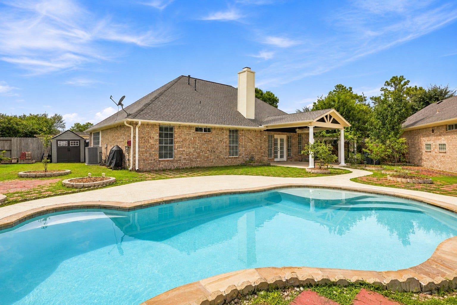 2611 Oxhill Court, Pearland, TX 77584 Sparkling in-ground pool, creating the perfect centerpiece for outdoor relaxation and entertaining.