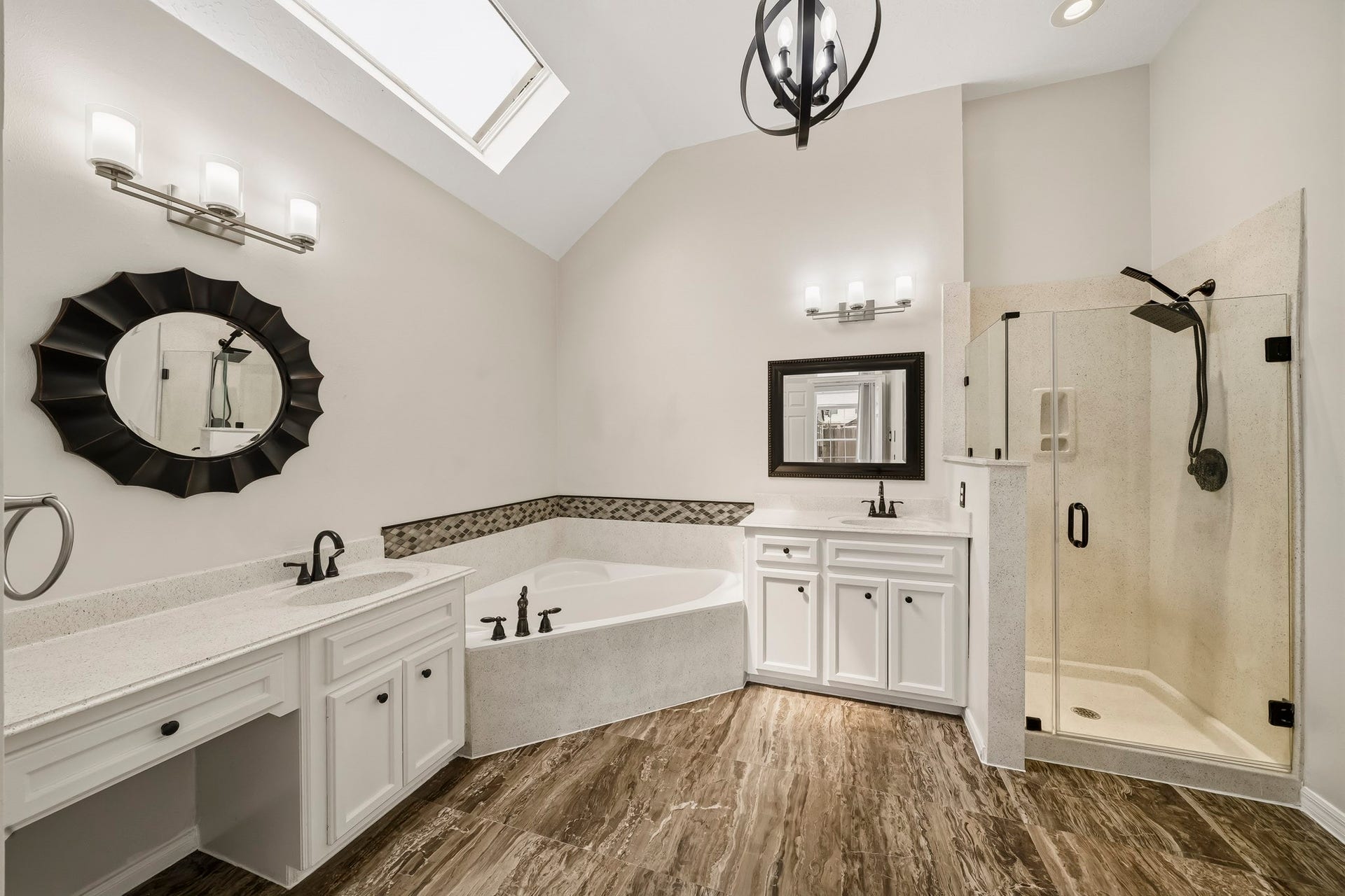 2611 Oxhill Court, Pearland, TX 77584 A separate glass-enclosed shower with a rainfall-style showerhead complements the space.
