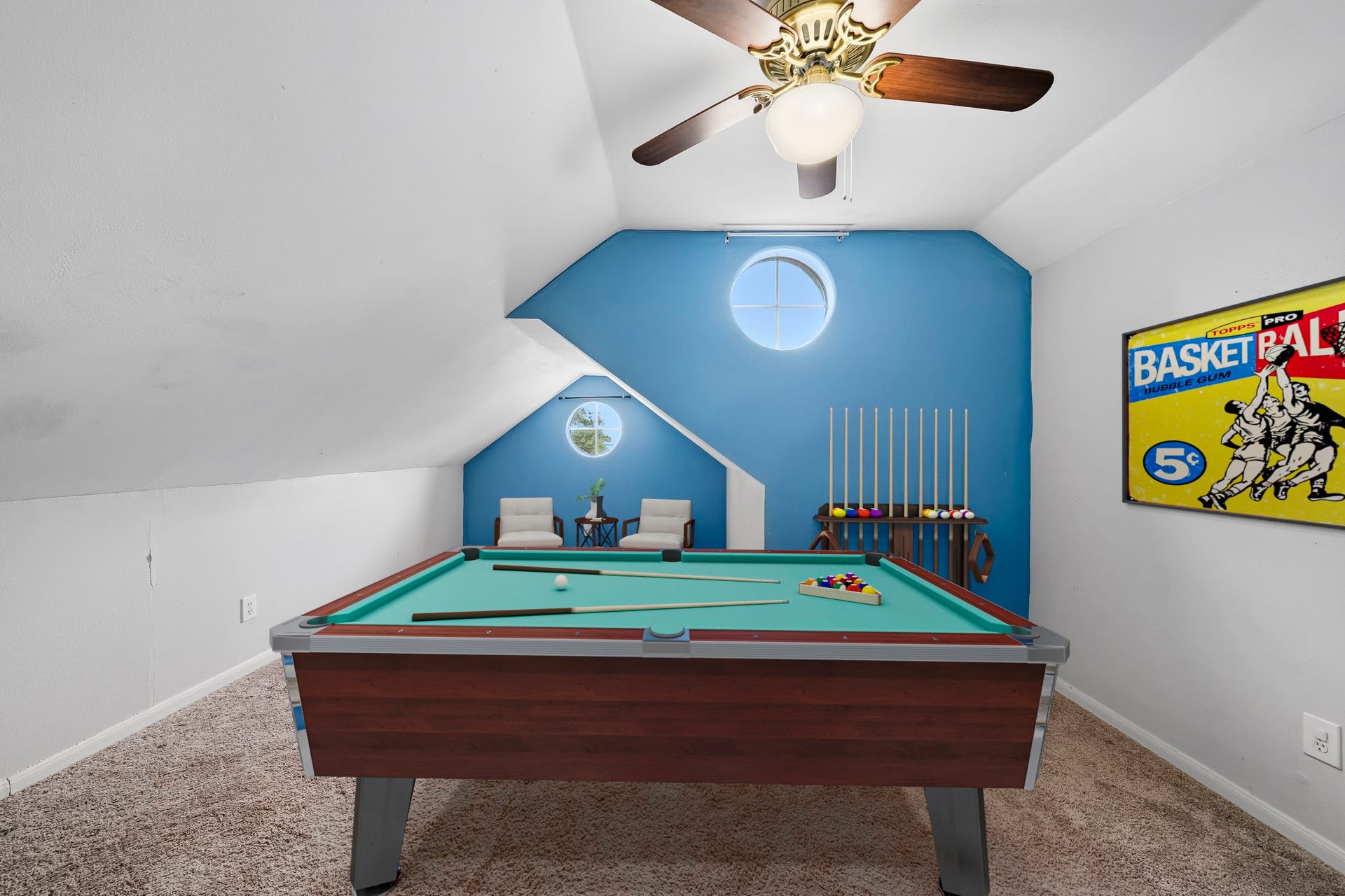 2611 Oxhill Court, Pearland, TX 77584 Virtually Staged: This spacious upstairs game room offers a flexible area ideal for recreation and entertaining. The room features a vaulted ceiling, comfortable carpeting, a ceiling fan, and an open layout with plenty of space for a pool table, gaming setup, or additional lounge seating.