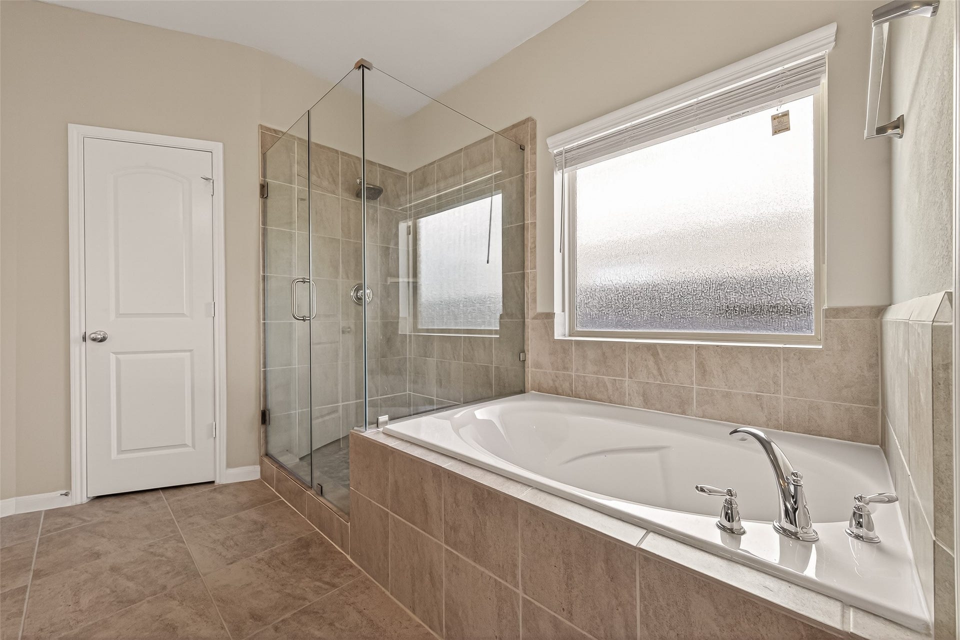 20427 Alpine Meadow Place, Richmond, TX 77407 The soaking tub is perfectly positioned beside large windows, creating a peaceful place to unwind.