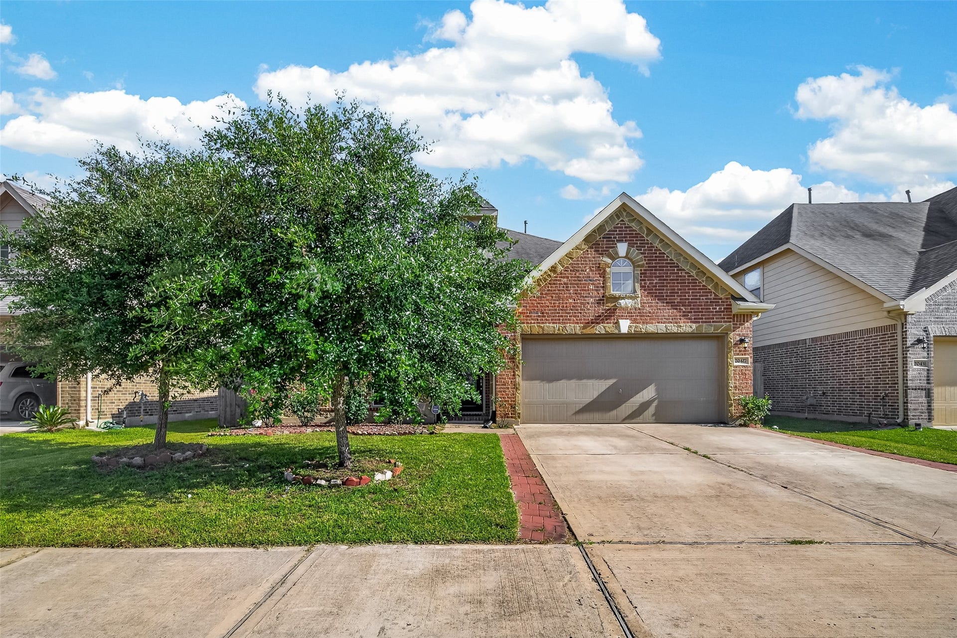 20427 Alpine Meadow Place, Richmond, TX 77407 Wide driveway and mature shade trees create a warm first impression as you arrive.