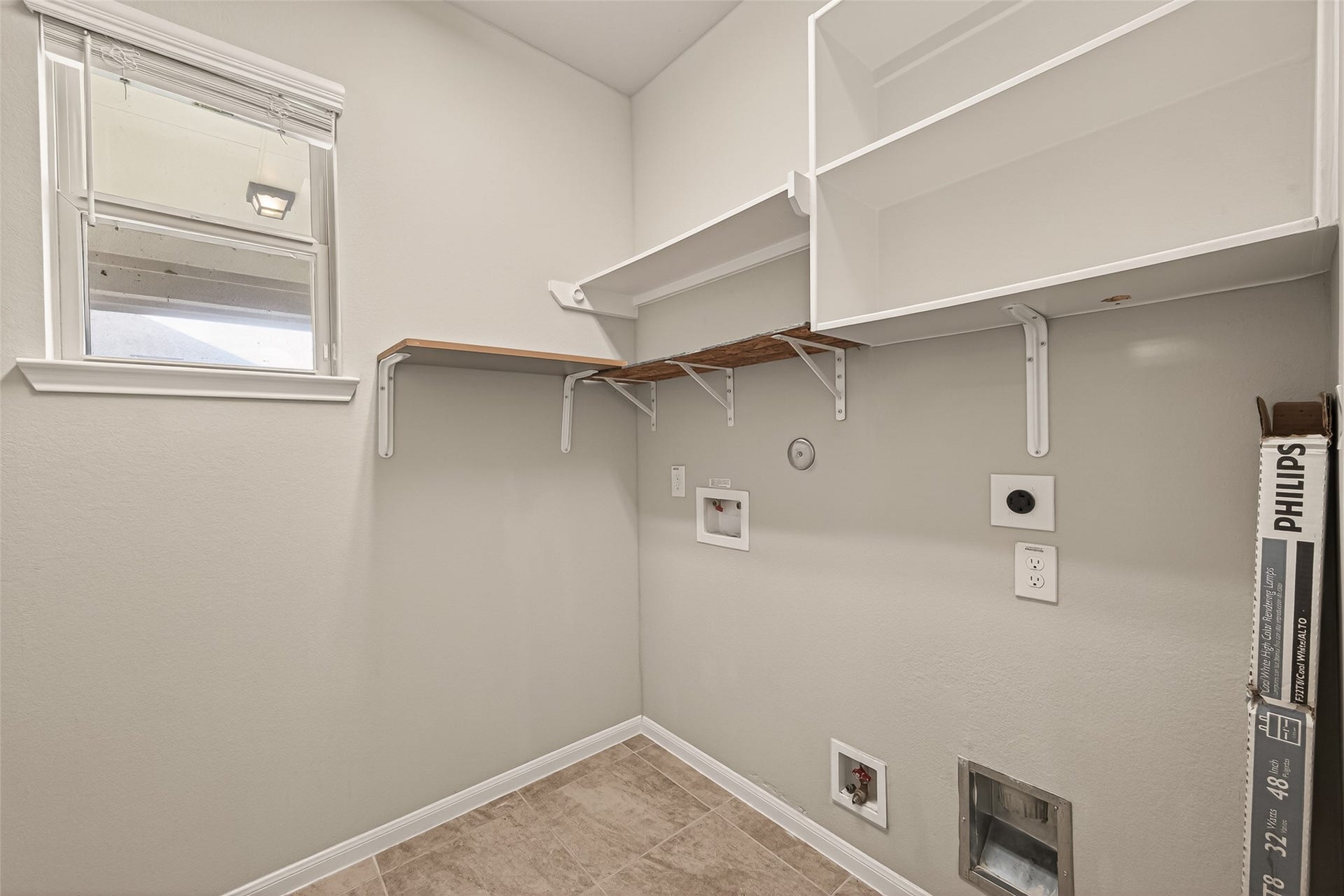 20427 Alpine Meadow Place, Richmond, TX 77407 Dedicated laundry room with built in storage to help keep daily tasks organized.