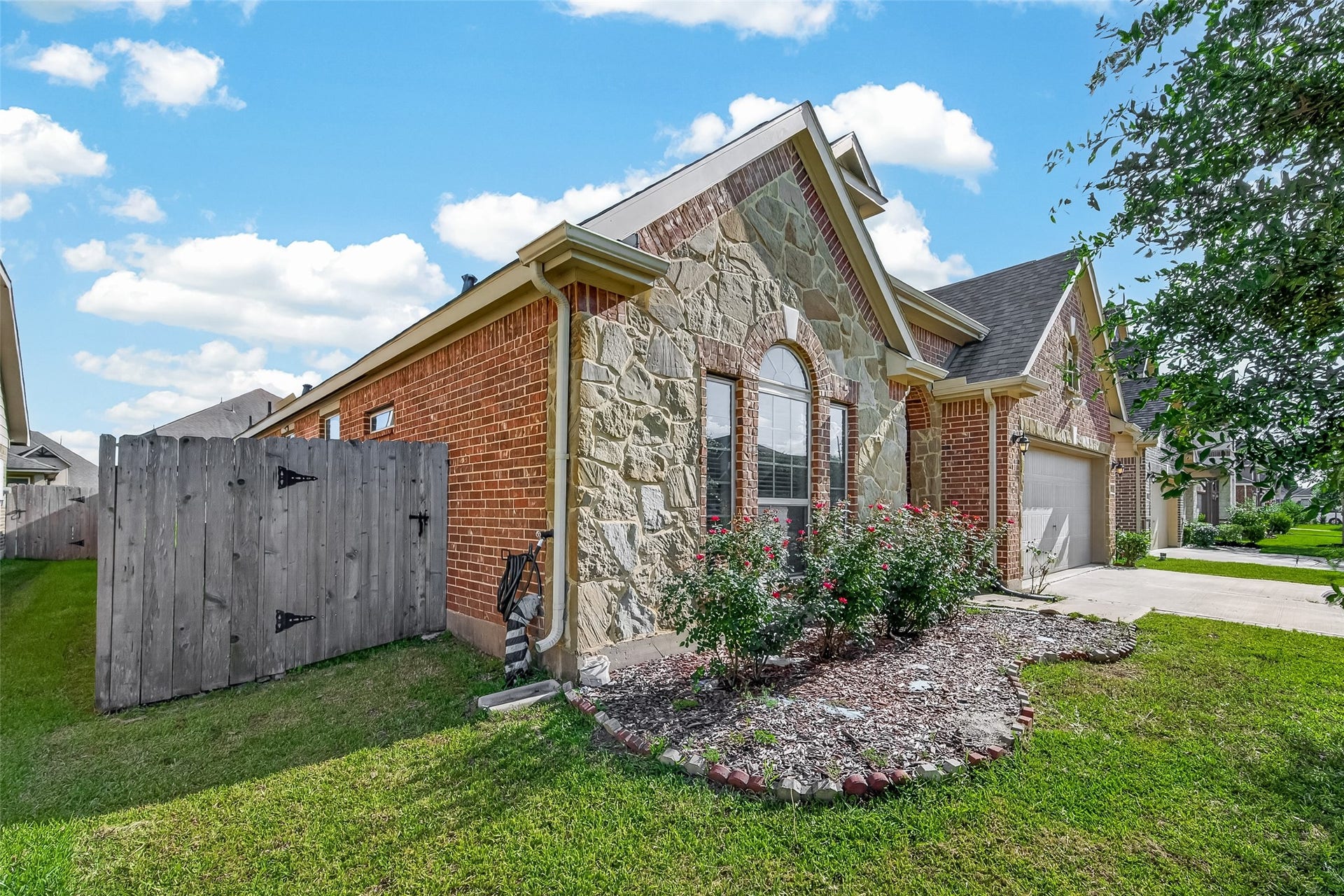 20427 Alpine Meadow Place, Richmond, TX 77407 A side view highlights the spacious lot and attractive landscaping surrounding the home.
