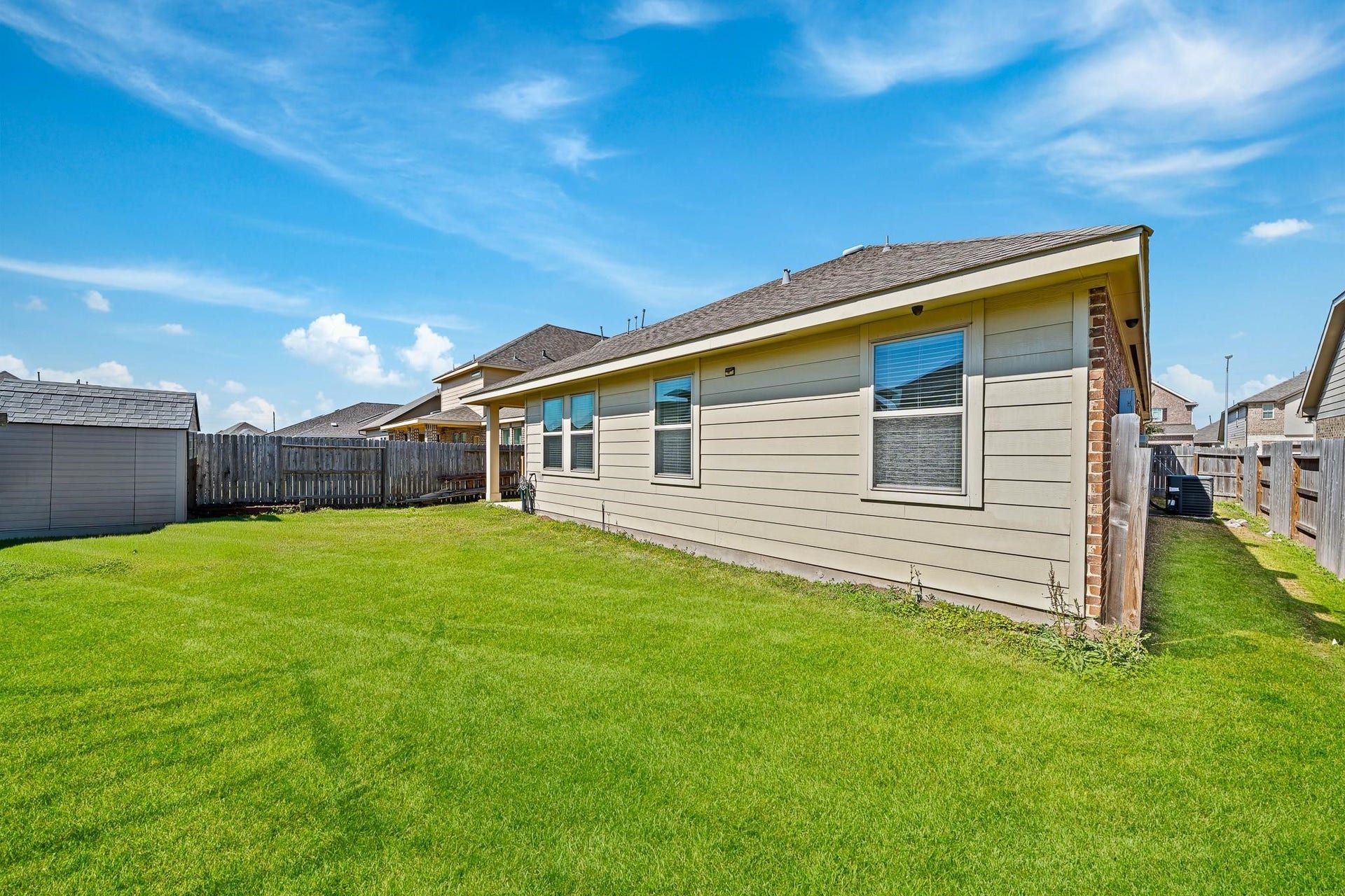 20427 Alpine Meadow Place, Richmond, TX 77407 The backyard provides plenty of open green space for play, pets, gardening, or entertaining.