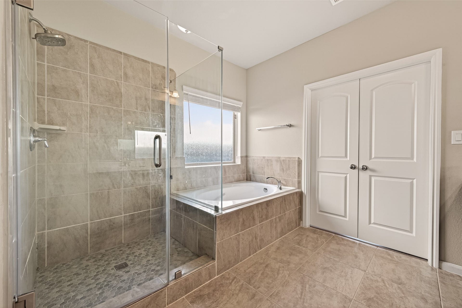 20427 Alpine Meadow Place, Richmond, TX 77407 The primary bath features a walk in shower, soaking tub, and a relaxing atmosphere.
