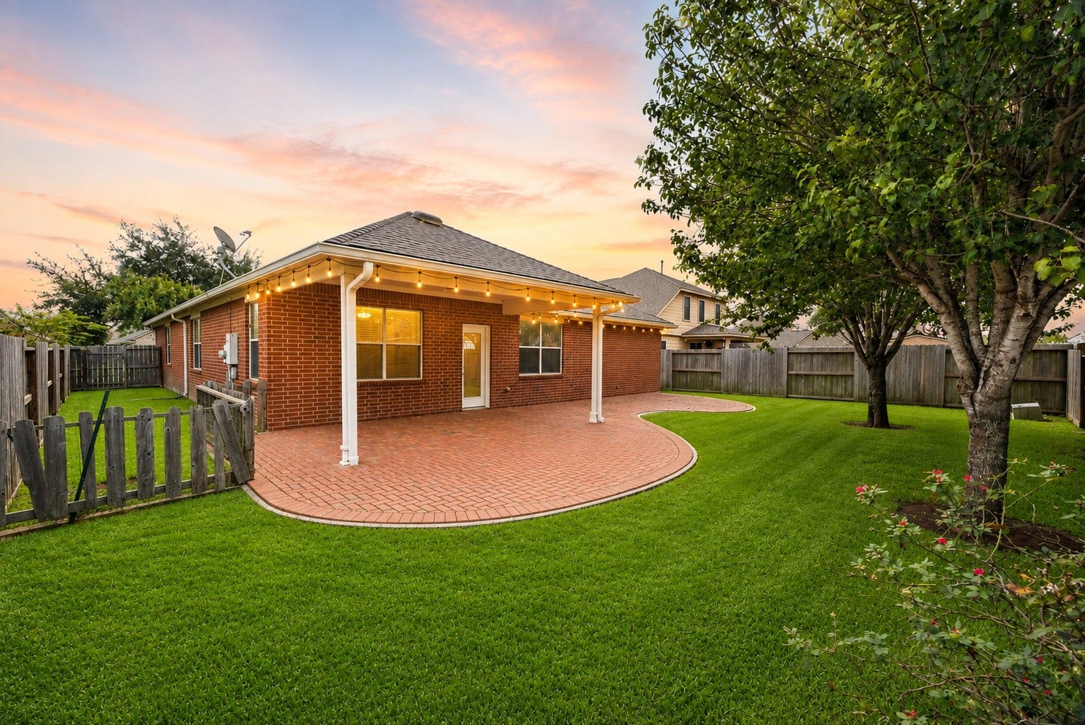 2006 Peonies Court, Pearland, TX 77581 Extending beneath the home's original roofline, the covered patio offers a substantial shaded setting for outdoor dining, casual gatherings, or simply unwinding beside the green lawn.