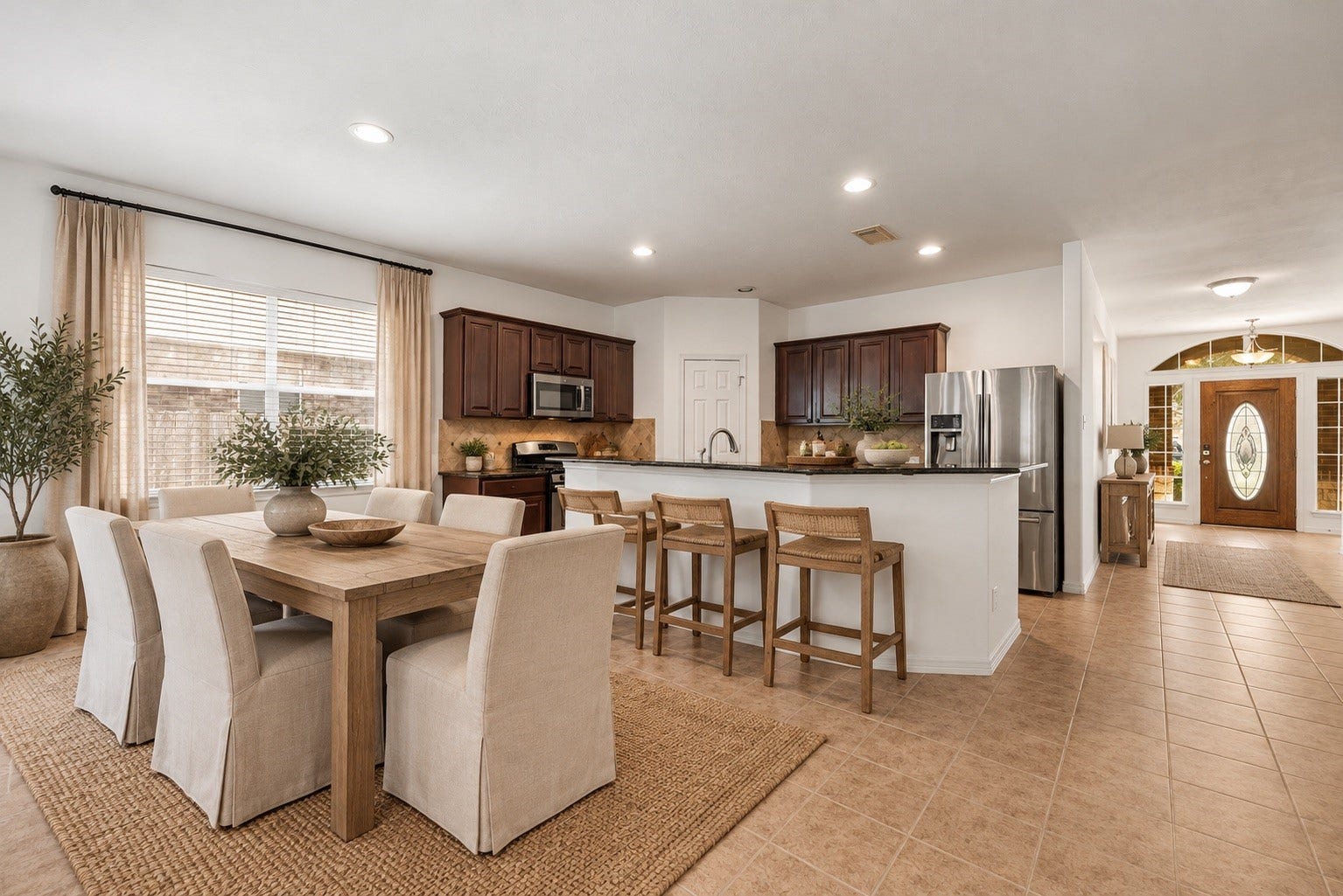 2006 Peonies Court, Pearland, TX 77581 Virtual staging showcases how the kitchen can accommodate a coordinated dining and cooking setup, highlighting its role as a natural gathering point within the open living area.