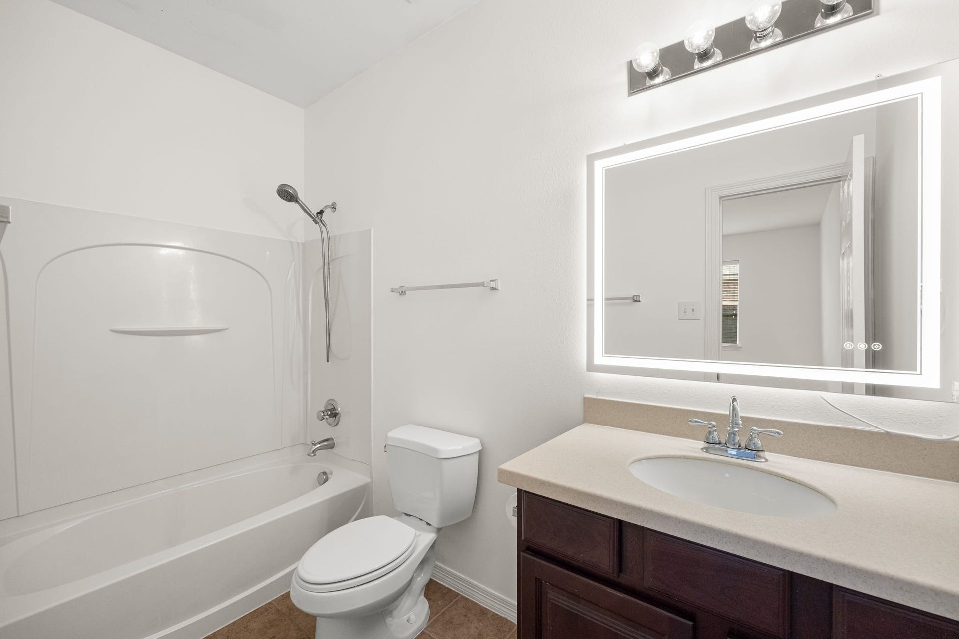 2006 Peonies Court, Pearland, TX 77581 The secondary bathroom features a vanity, a well-lit mirror, and a tub-shower combination, bringing the everyday essentials together in a practical arrangement.