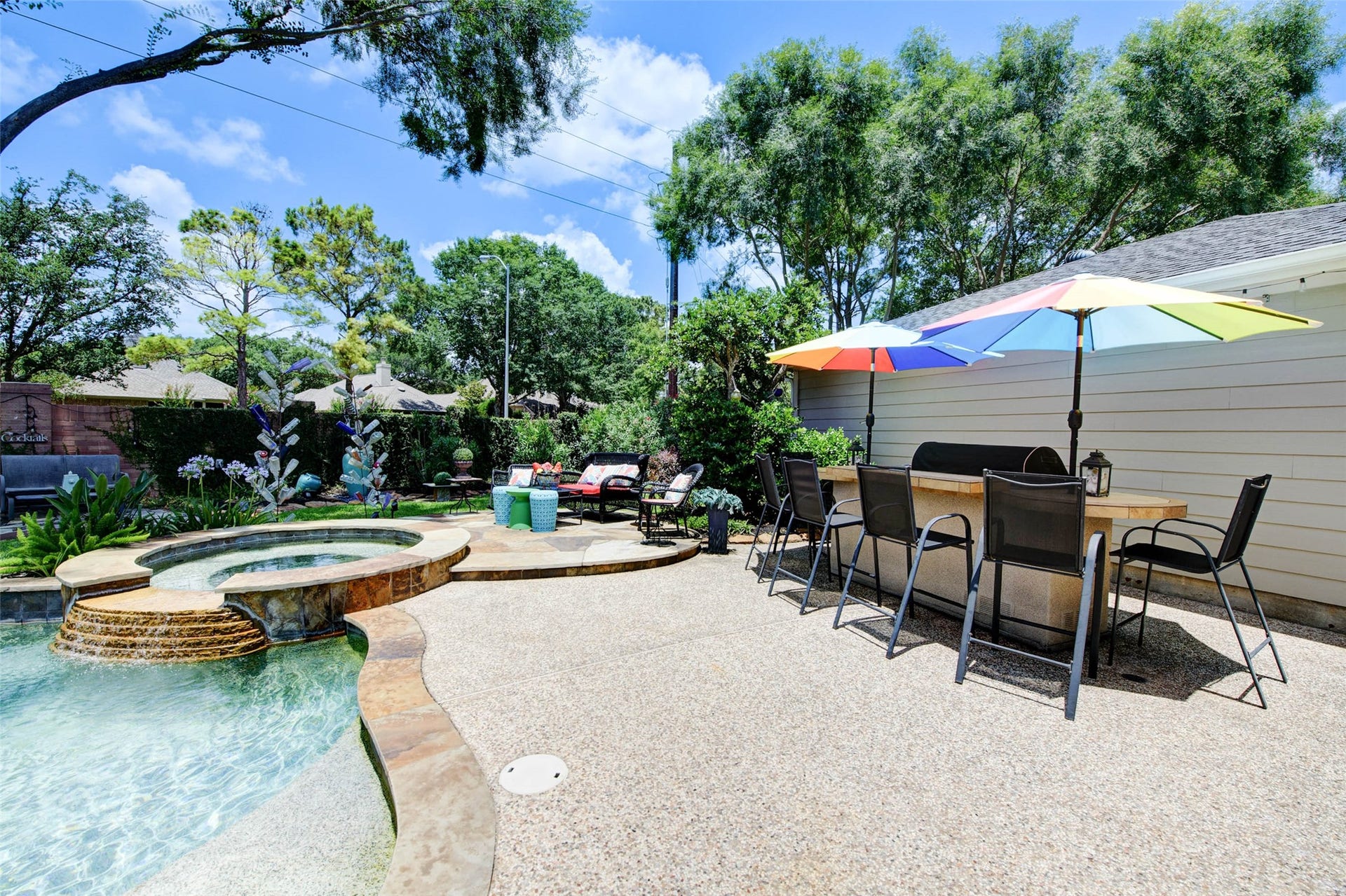 Enjoy a lush, private oasis with vibrant plants and trees in this beautifully maintained backyard retreat.