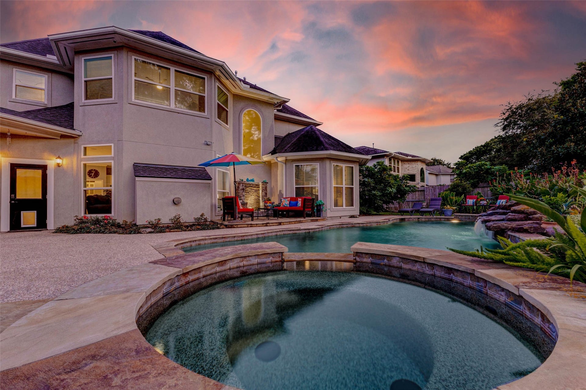 This stunning home features a spacious backyard with a luxurious pool and hot tub, perfect for entertaining. The elegant two-story exterior is complemented by a beautifully landscaped garden, creating a serene atmosphere. Mosquito system with 100 heads around the whole backyard, fences, eves, gutters, trees and beds and around to the garage.