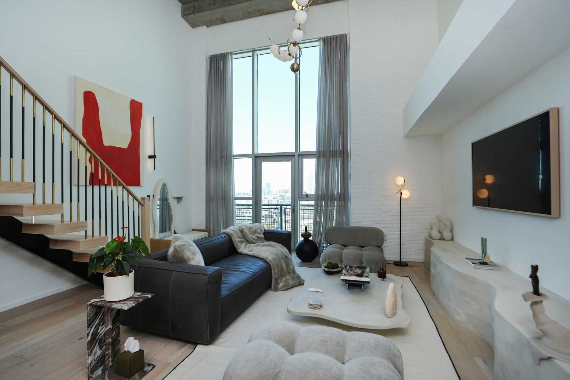 Move right in to this designer-furnished living area with custom lime wash concrete console, Samsung Frame TV, and sunset views over the Medical Center