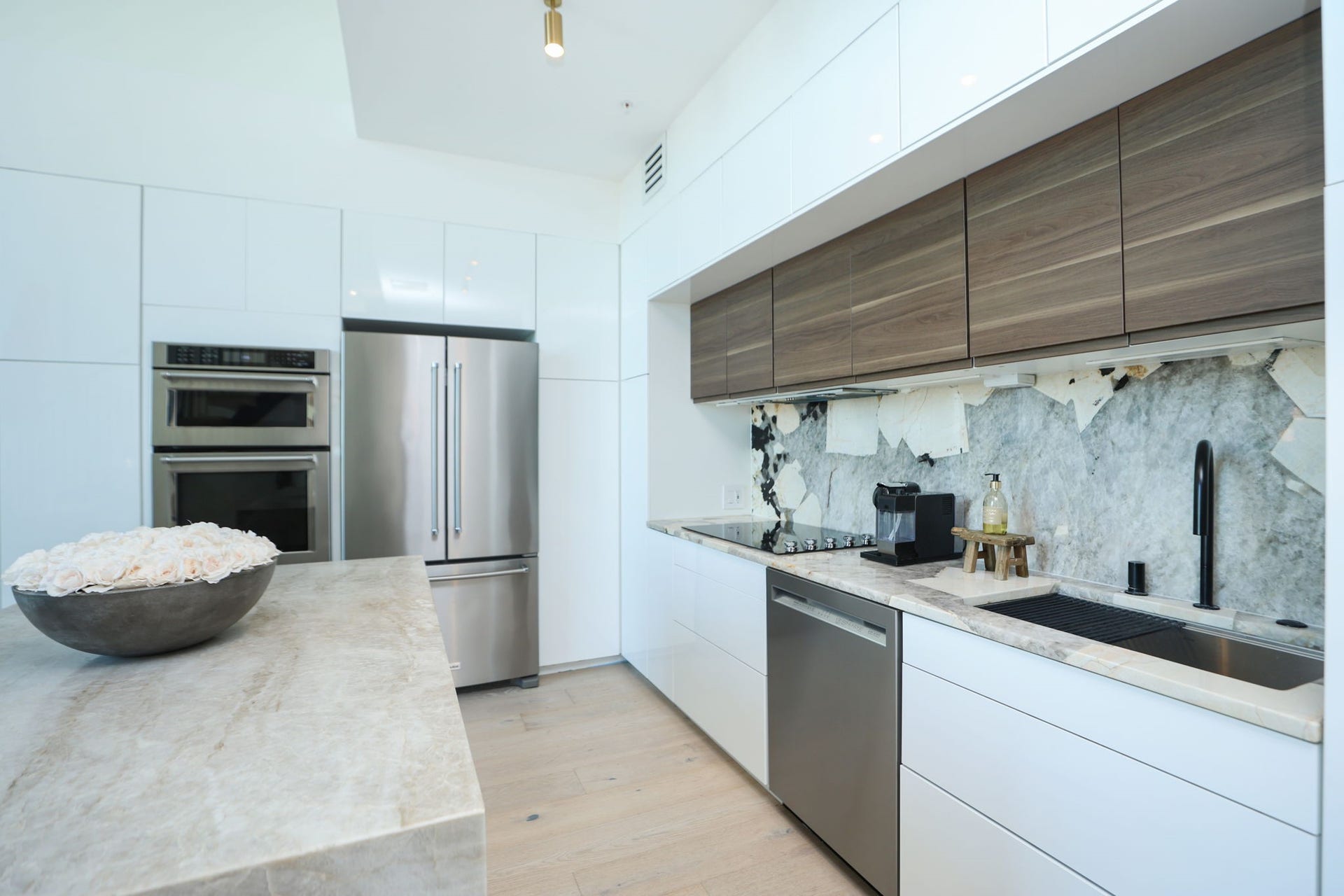 Cook with ease in this functional kitchen featuring KitchenAid stainless steel appliances and abundant self-closing cabinetry. Also available are Air fryer, Nespresso and flatware also included.