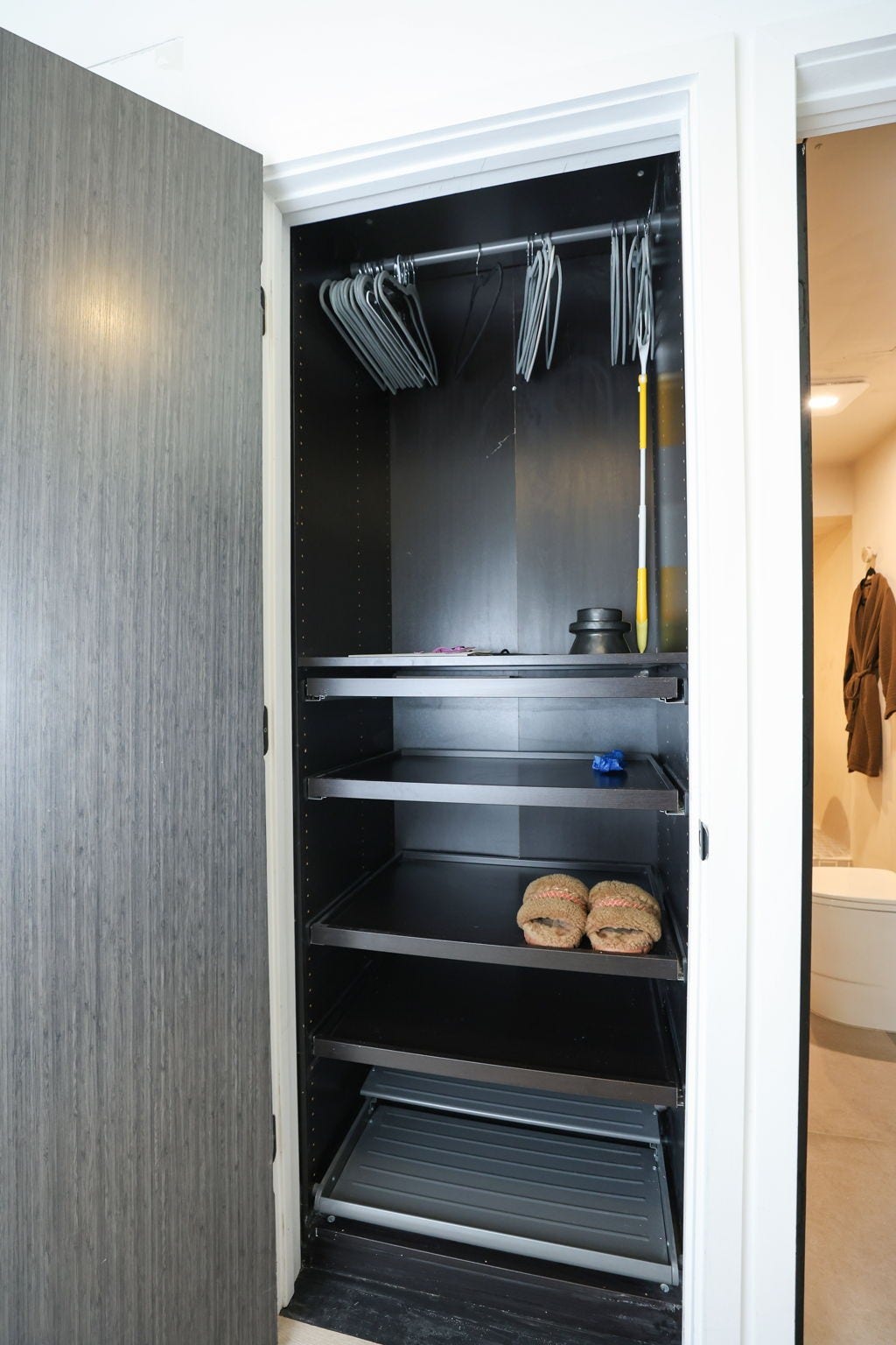 Thoughtfully designed entryway closet featuring custom built-in shelving, hanging space, and organized storage.