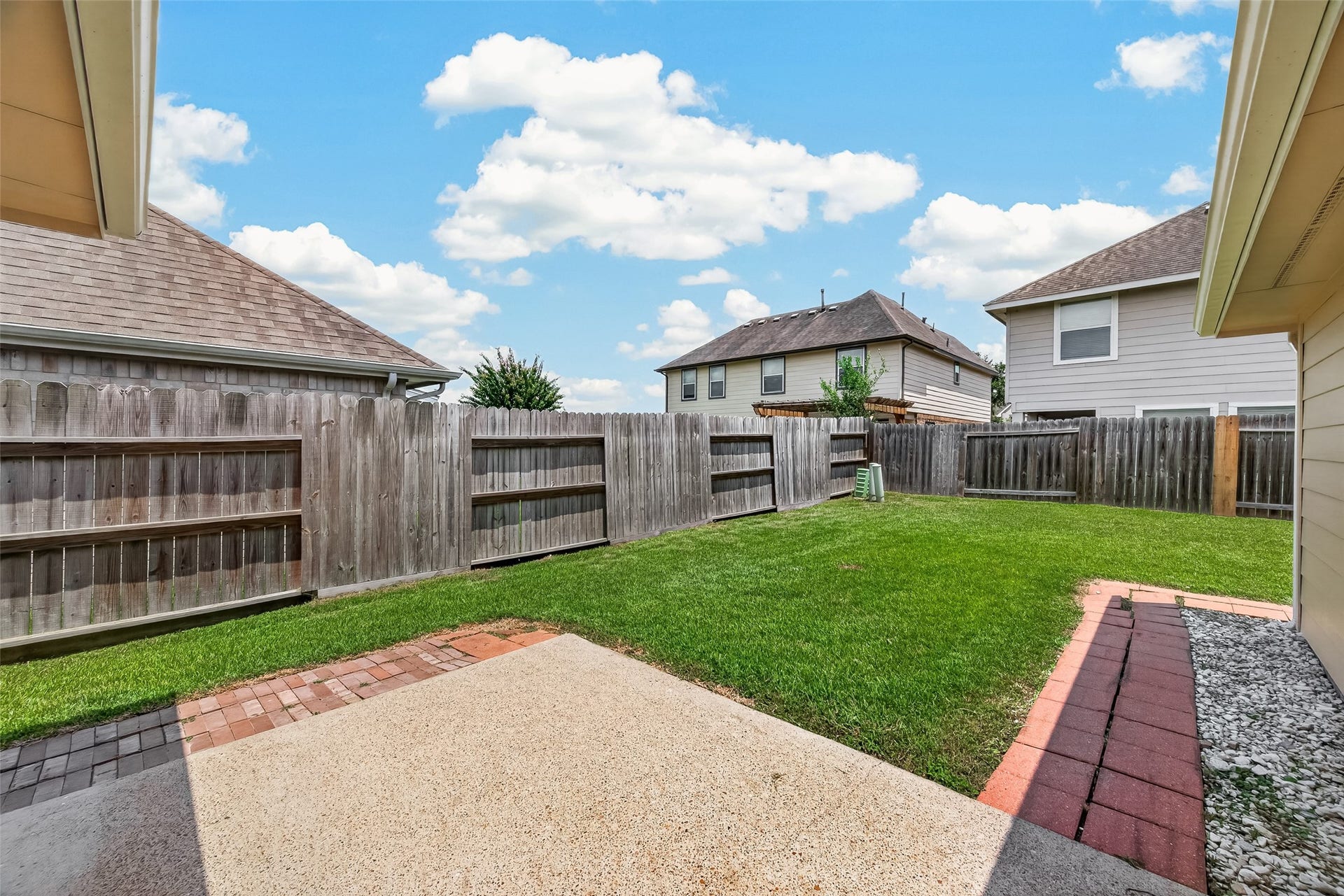 4714 Lake Rim Drive, Alvin, TX 77511 Rear Patio Space with walkway to the storage building