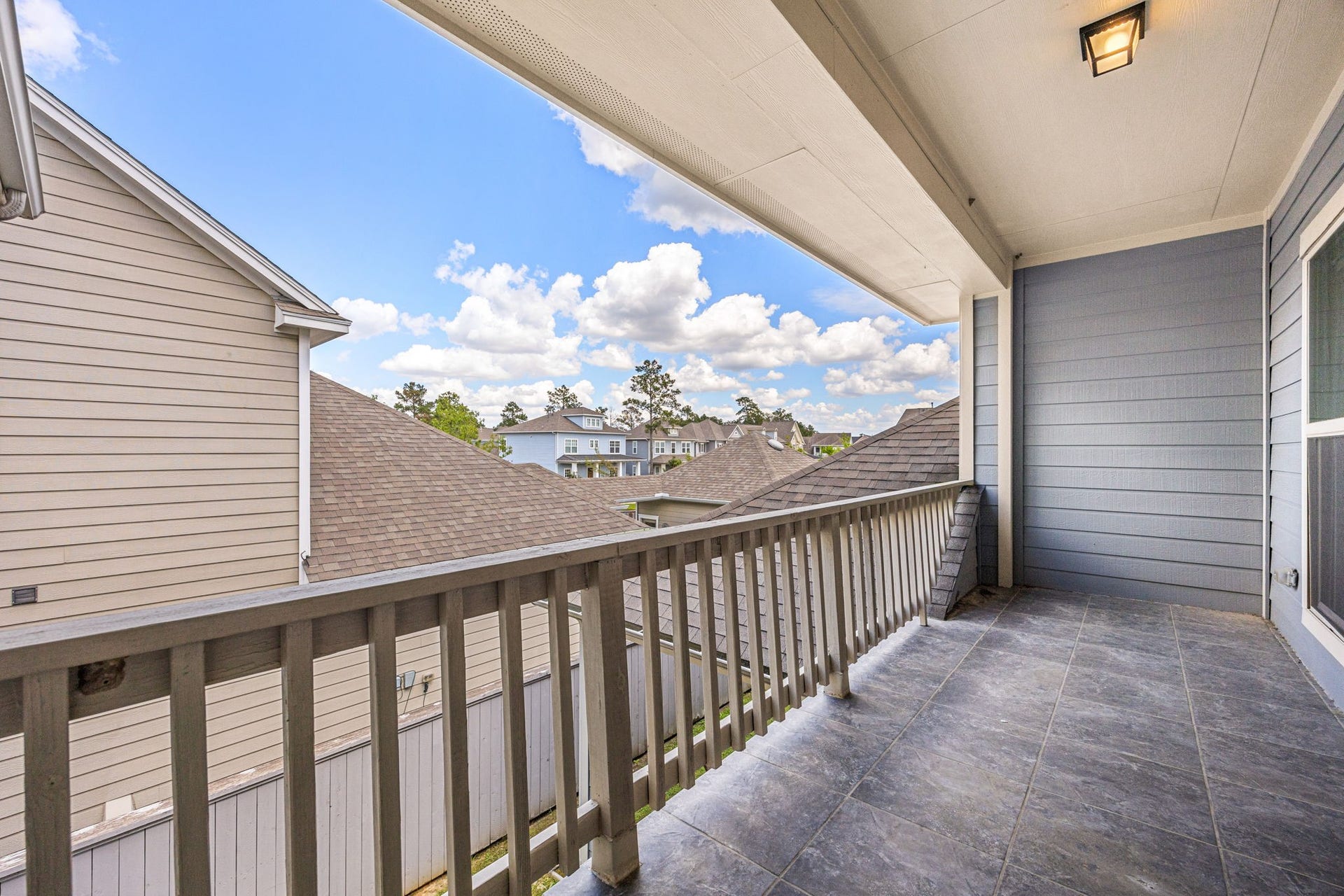 14 Kendrick Pines Boulevard, The Woodlands, TX 77389 Step out onto the private second-story balcony, a rare and sophisticated retreat offering elevated views and a refreshing breeze. This covered outdoor space serves as a seamless extension of the upstairs gameroom, perfect for enjoying a morning coffee or unwinding at sunset. With its clean lines and airy atmosphere, it provides an additional layer of luxury and a peaceful escape within the home.