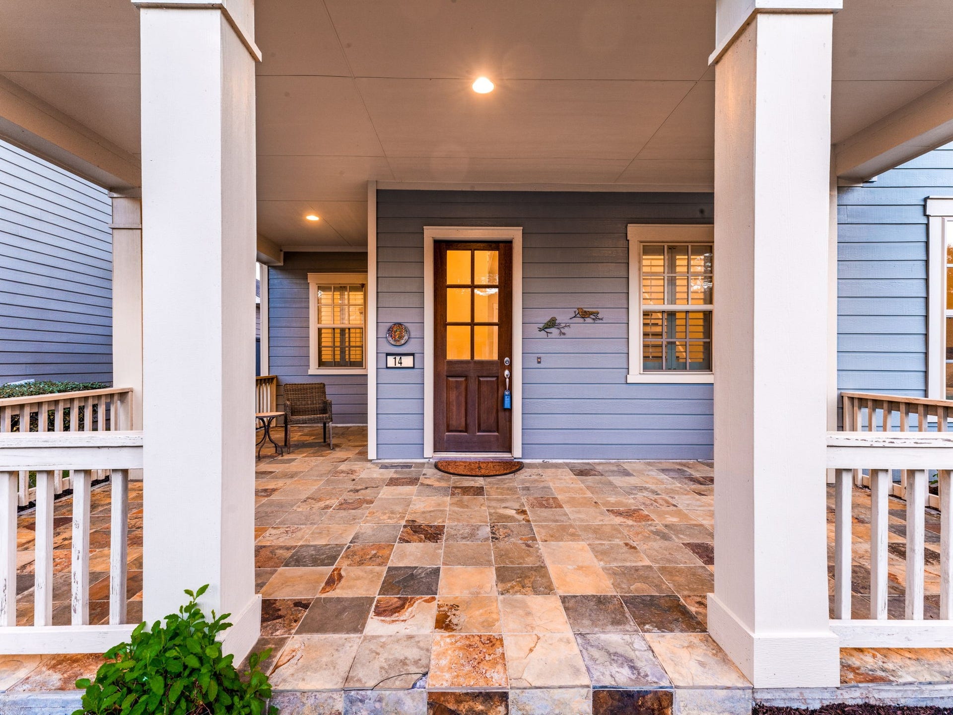 14 Kendrick Pines Boulevard, The Woodlands, TX 77389 Charming covered front porch with rich slate tile flooring creates a warm, upscale first impression, an ideal spot to unwind, enjoy your morning coffee, or welcome guests with style and sophistication.