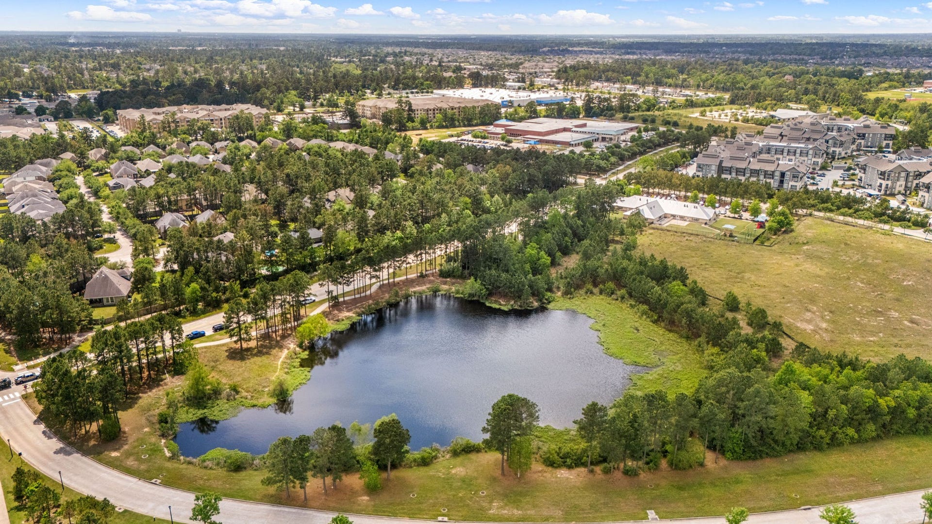 14 Kendrick Pines Boulevard, The Woodlands, TX 77389 This stunning aerial view showcases the unparalleled lifestyle of Creekside Park in The Woodlands. Surrounded by lush greenery and serene community lakes, this residence is perfectly positioned just moments from world-class amenities.
