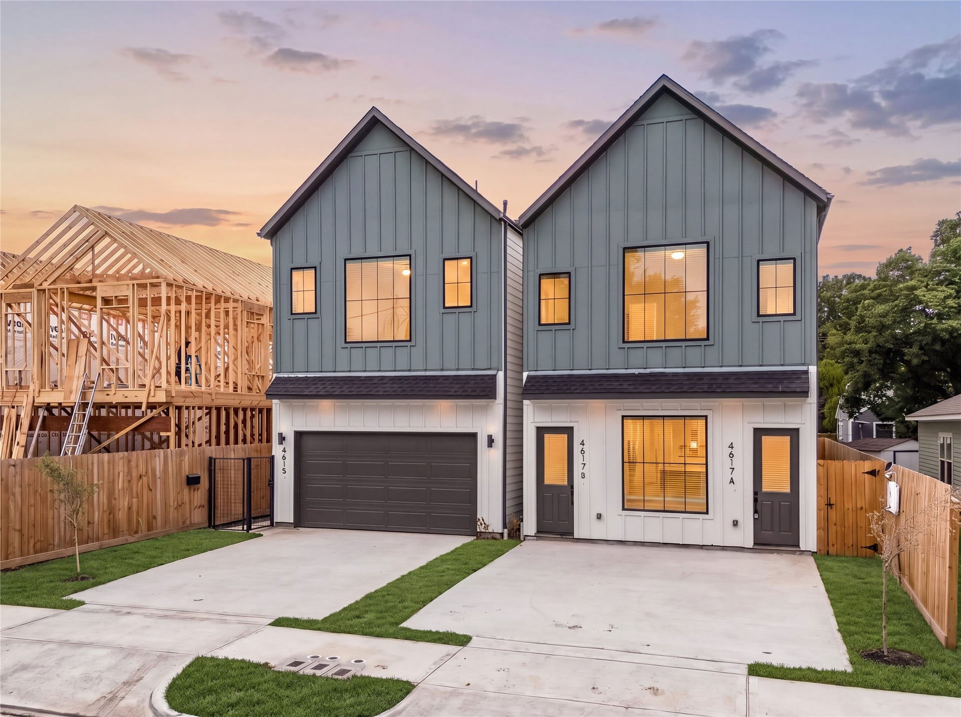 Striking modern new construction home featuring a private driveway and attached garage.