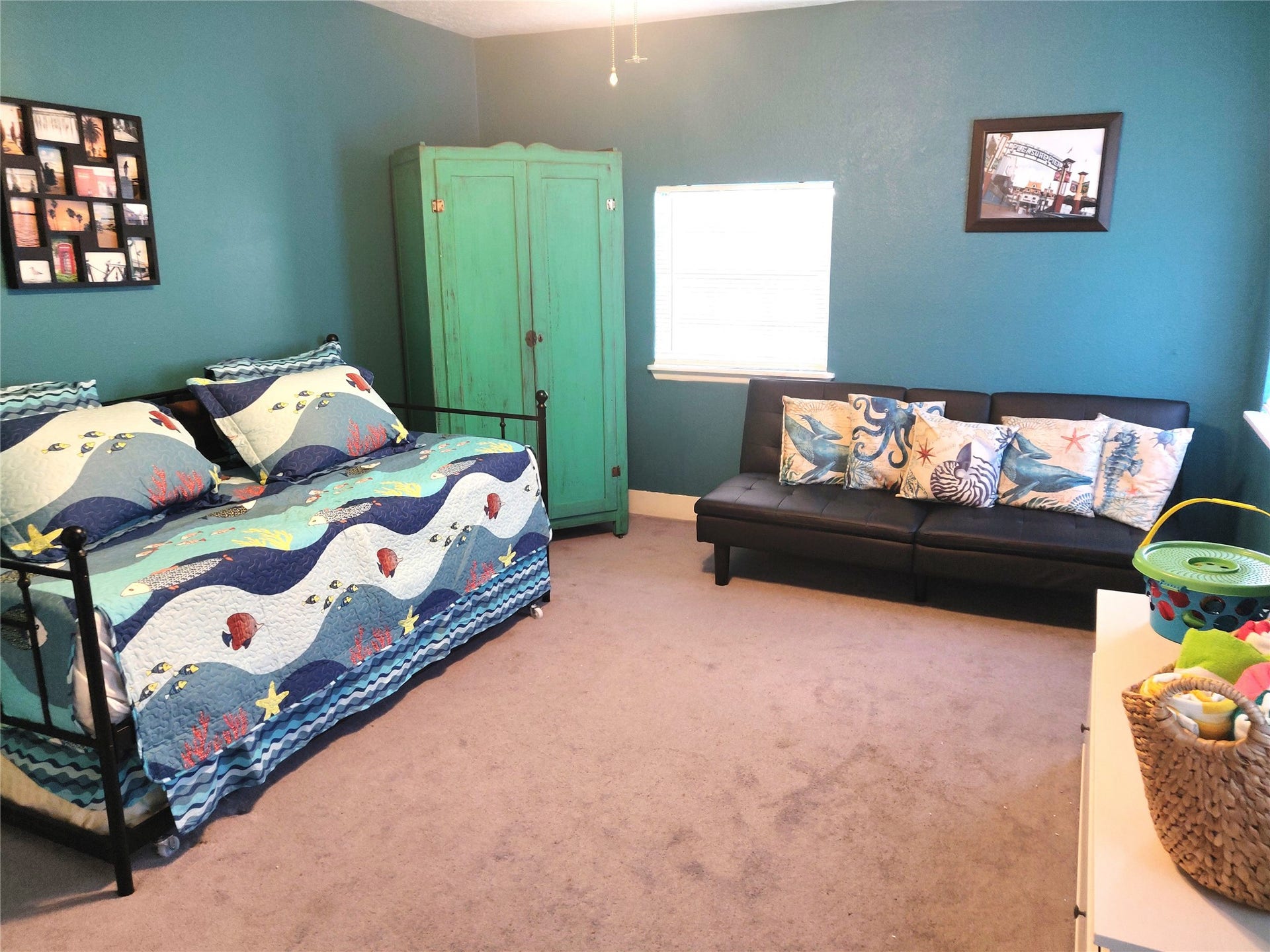 4711 Avenue S, Galveston, TX 77551 Versatile flex room, perfect for remote work, yoga, or additional sleeping space with a comfy pull-out couch and trundle bed under the day-bed