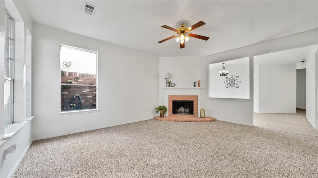 2919 Blue Dawn Drive, Katy, TX 77449 The inviting living room features a cozy fireplace and flows into a formal dining room and separate breakfast area.