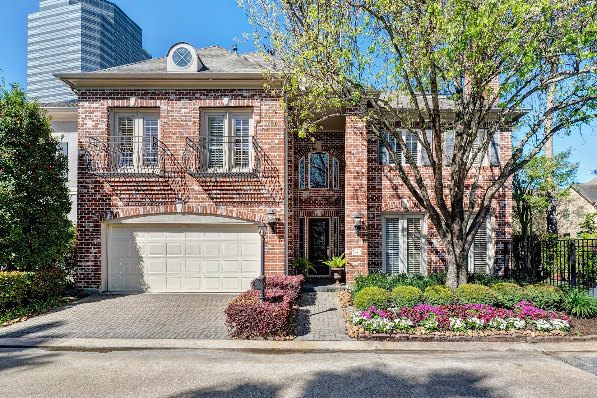 On one of the largest corner lots in the gated enclave of Wynden Oaks Estates, this brick traditional sits behind a hand-planted garden of impatiens, barberry, and boxwood that signals genuine pride of ownership from the curb.