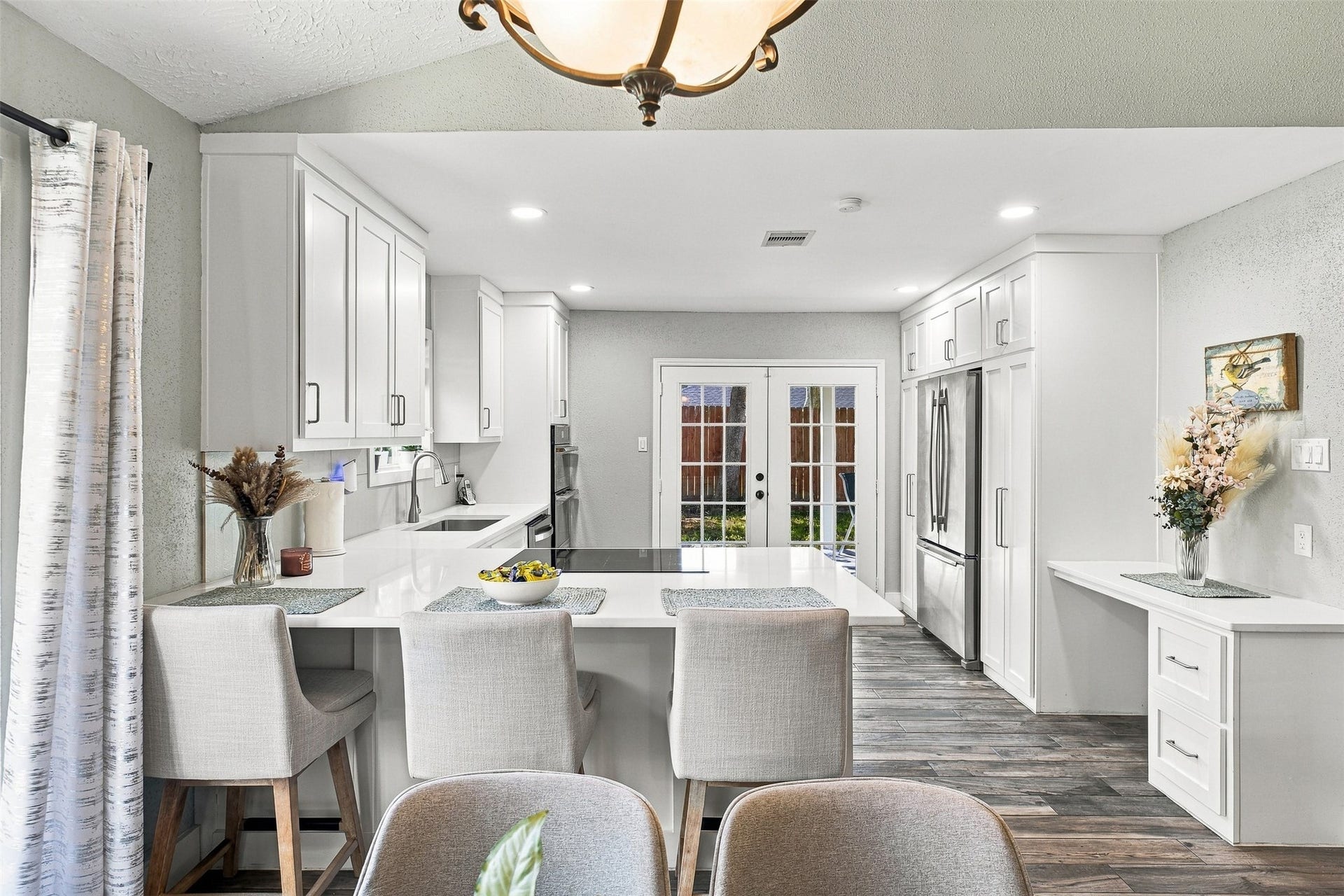 22611 Carter Moir Lane, Katy, TX 77449 Beautifully updated kitchen featuring white cabinetry, quartz countertops, generous counter space, breakfast seating, and recessed lighting.