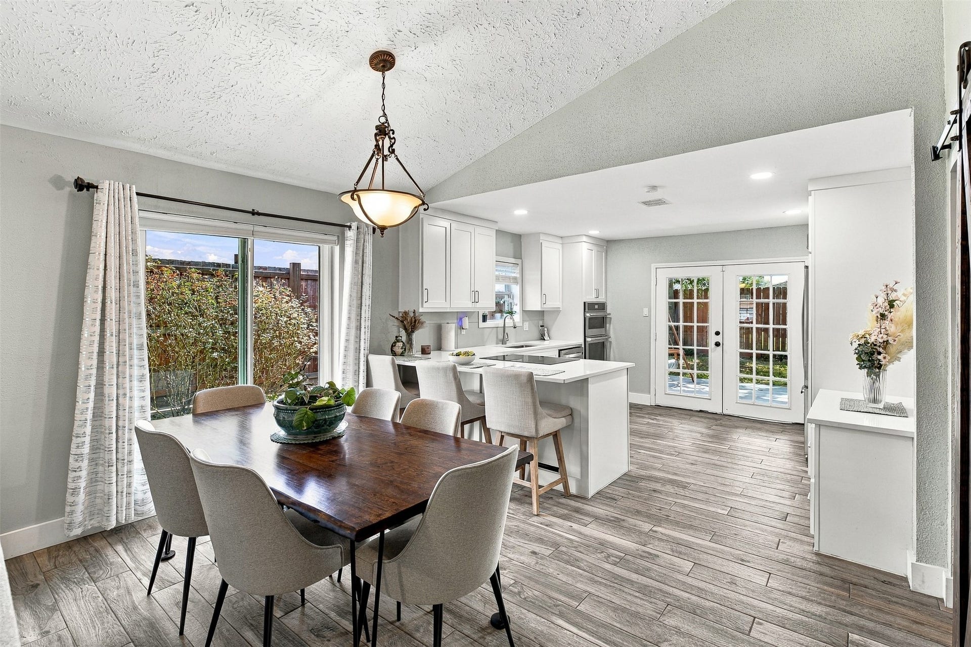 22611 Carter Moir Lane, Katy, TX 77449 Bright and inviting open-concept living! The dining area flows seamlessly into the beautifully updated kitchen, with vaulted ceilings, abundant natural light, breakfast bar seating, and French doors opening to the backyard.