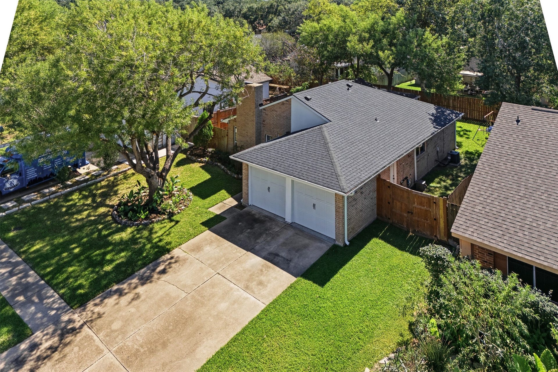 22611 Carter Moir Lane, Katy, TX 77449 Aerial view showcases the home's roofline, two-car garage, mature trees, and established homesite.