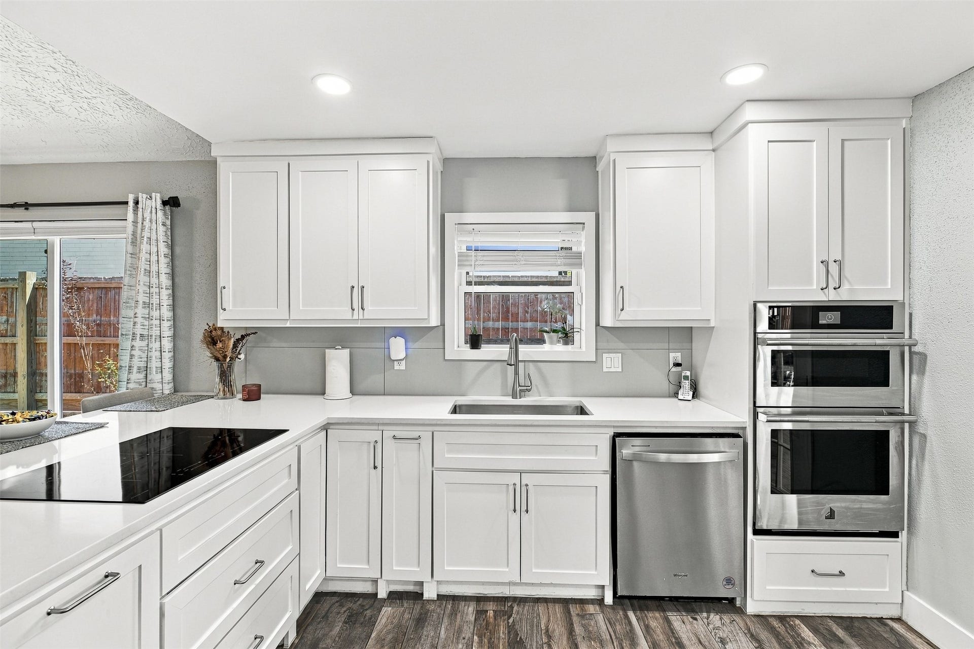 22611 Carter Moir Lane, Katy, TX 77449 Updated kitchen with modern white cabinetry with handles, quartz countertops, stainless steel appliances, undermount sink, and abundant storage for your inspired chef kitchen.