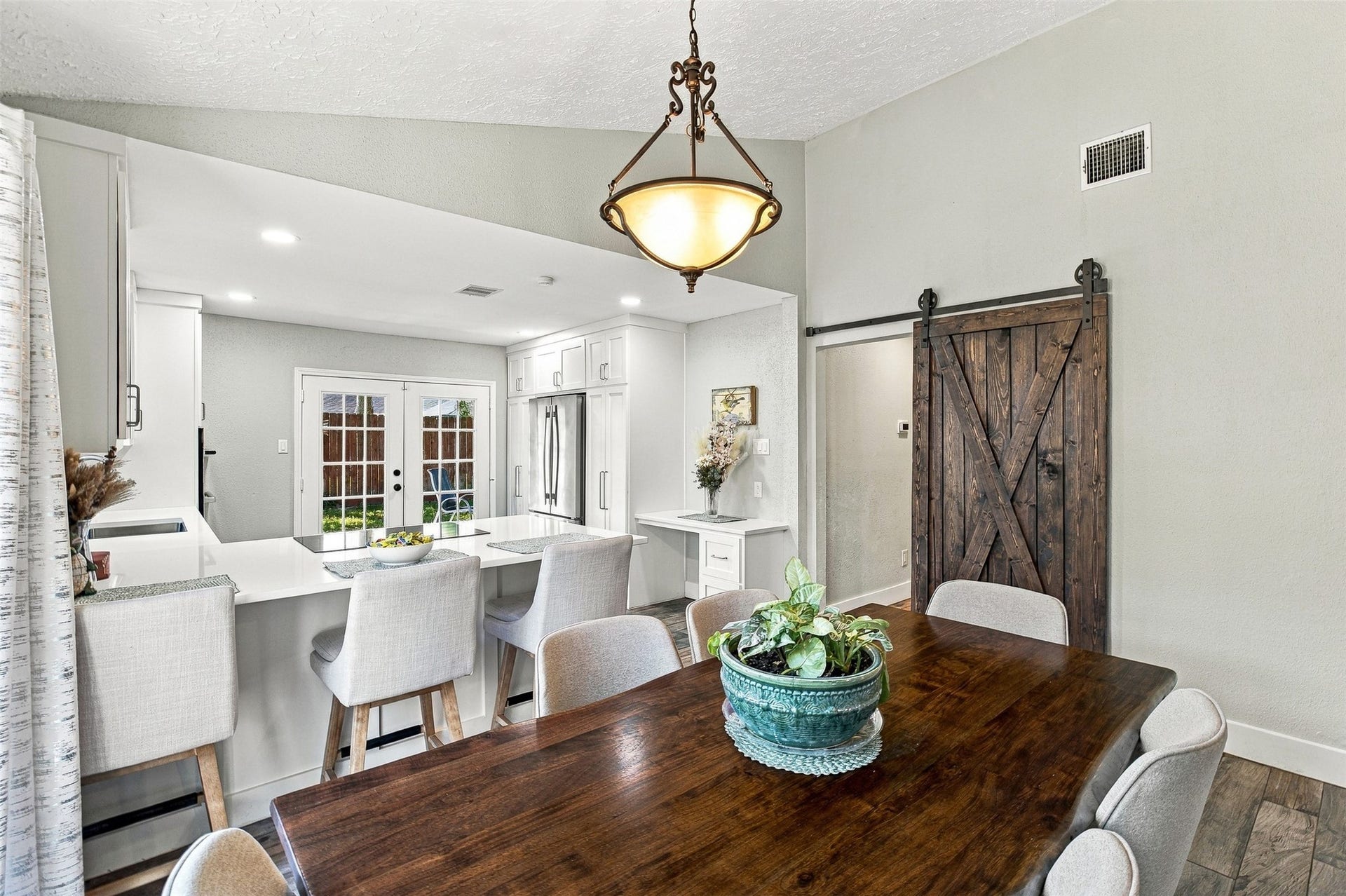 22611 Carter Moir Lane, Katy, TX 77449 Open dining and kitchen layout creates an inviting space for everyday living and entertaining. Sliding barn door adds character and warmth.
