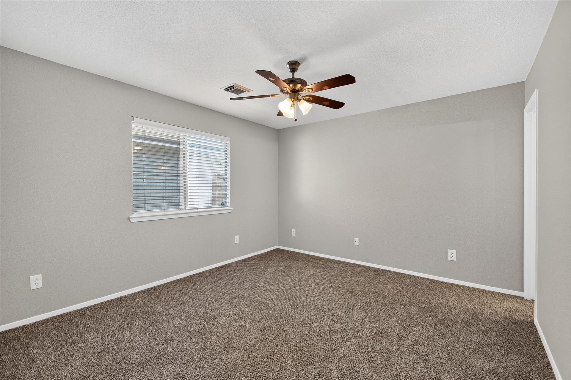 19547 Fletcher Way Drive, Houston, TX 77073 The primary bedroom features fresh neutral paint, new carpet, a ceiling fan, and private bath access.