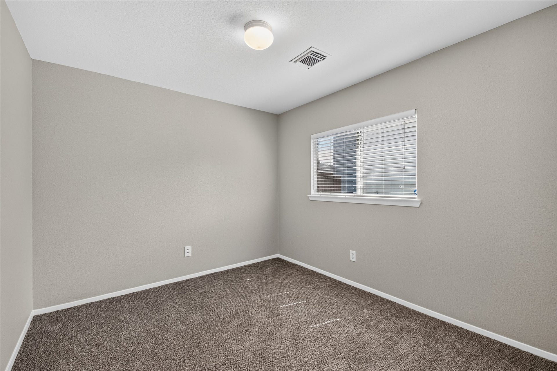 19547 Fletcher Way Drive, Houston, TX 77073 Fresh paint and new carpet continue into this secondary bedroom with natural light from the window.