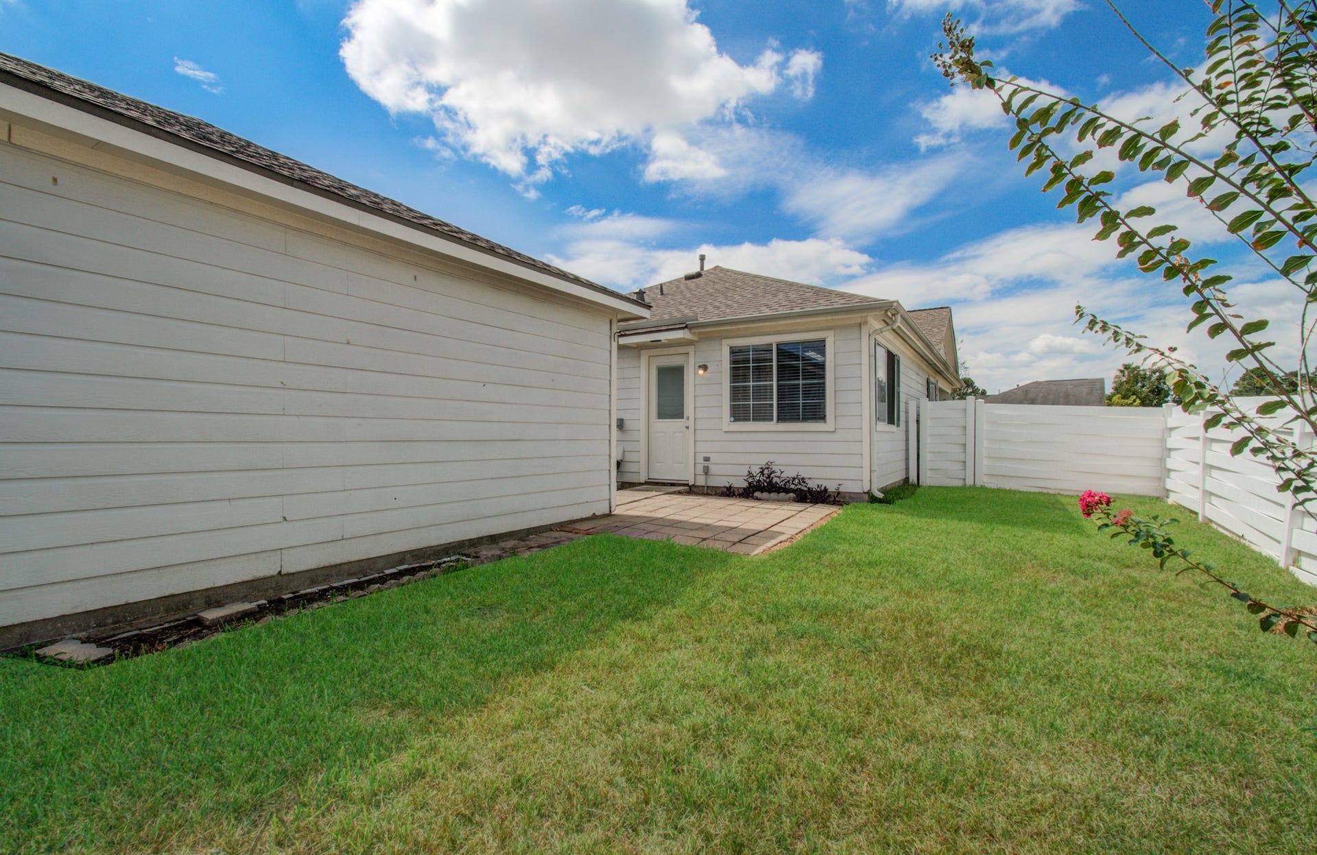 19547 Fletcher Way Drive, Houston, TX 77073 The fully fenced backyard offers open lawn space ready for play, pets, gardening, or outdoor entertaining.