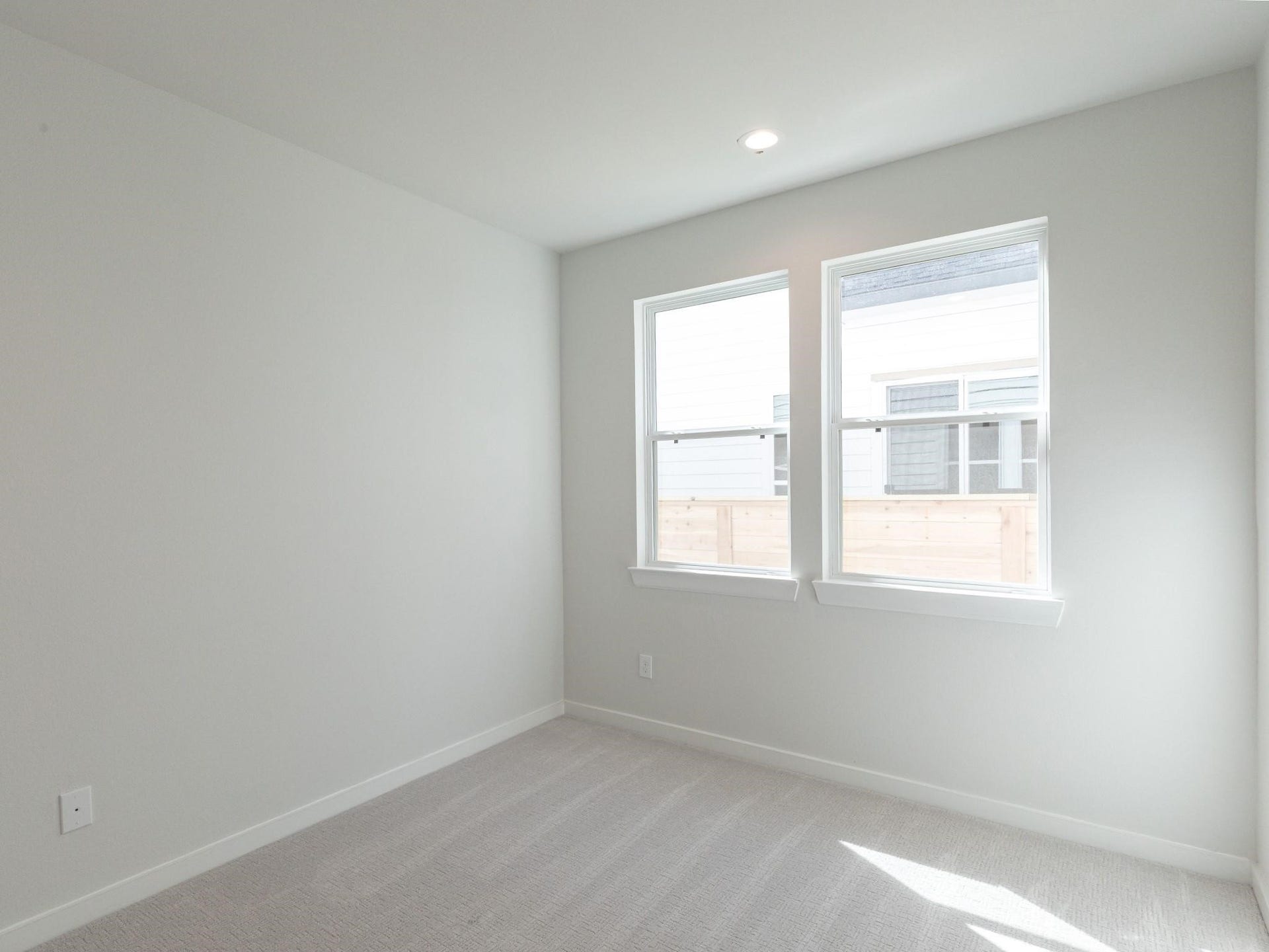 751 N Emile Street, Houston, TX 77020 Bright and airy secondary bedroom with neutral walls, plush carpeting, and two large windows inviting natural light.
Note: Photos 2022
