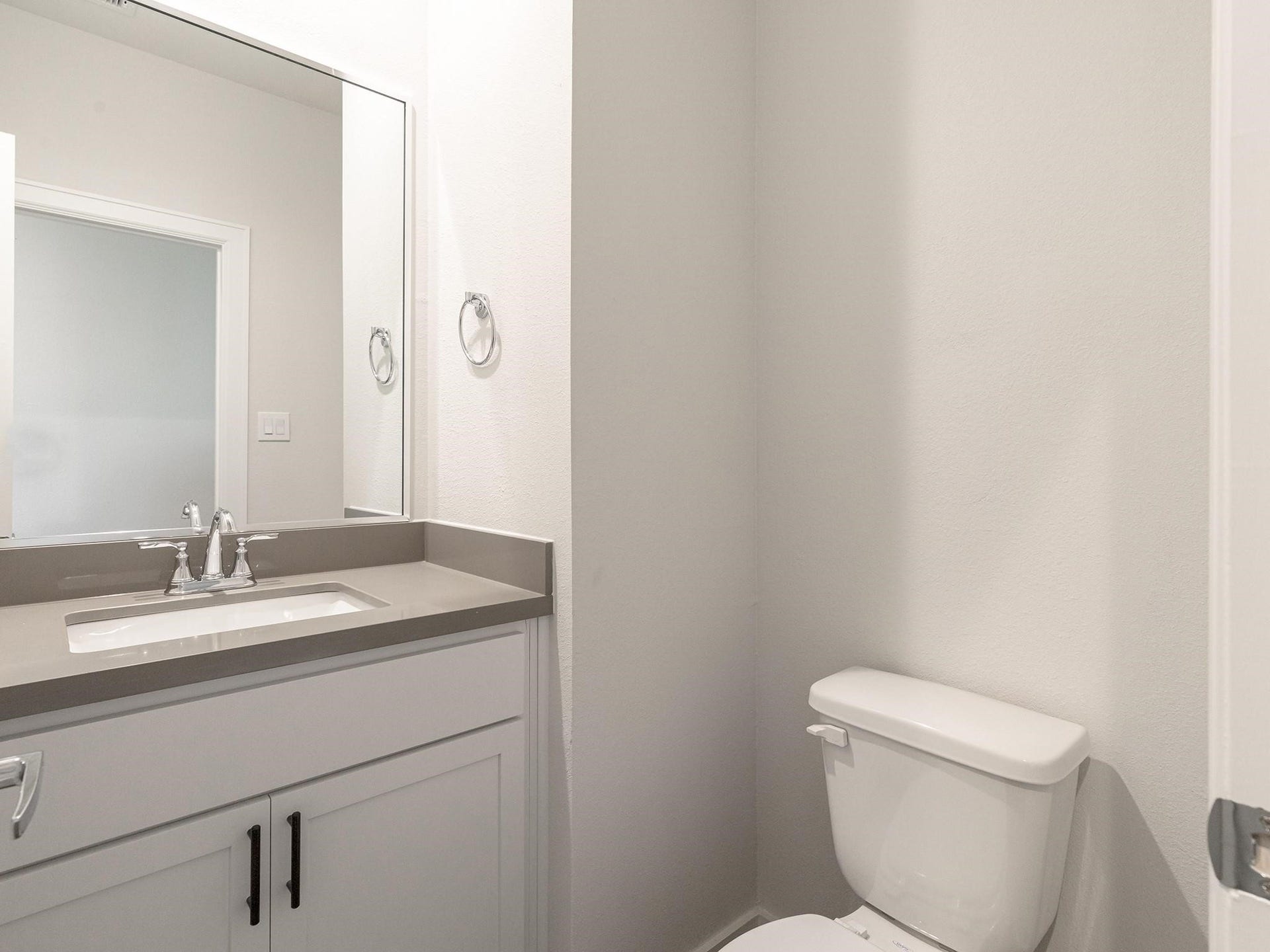 751 N Emile Street, Houston, TX 77020 Modern half bathroom featuring a sleek vanity with a polished countertop, undermount sink, and contemporary fixtures, complemented by a clean, neutral color palette.
Note: Photos 2022
