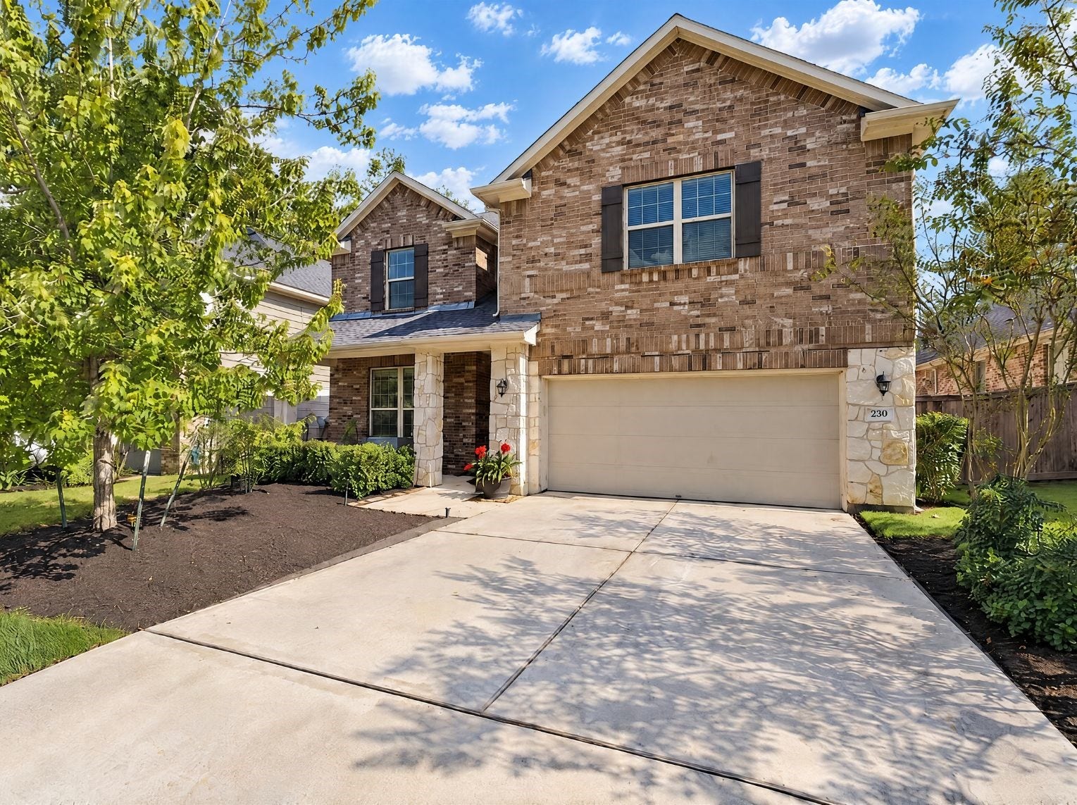 230 Elianne Lace Court, Conroe, TX 77318 Stately two-story home with a brick and stone faade, dark shutters, and a covered front entry. A two-car garage and wide concrete driveway pair with landscaped mulch beds for solid curb appeal.
This photo has been digitally staged to illustrate the possibilities of the homes aesthetic and potential design. Some furnishings and dcor shown are for visual inspiration.