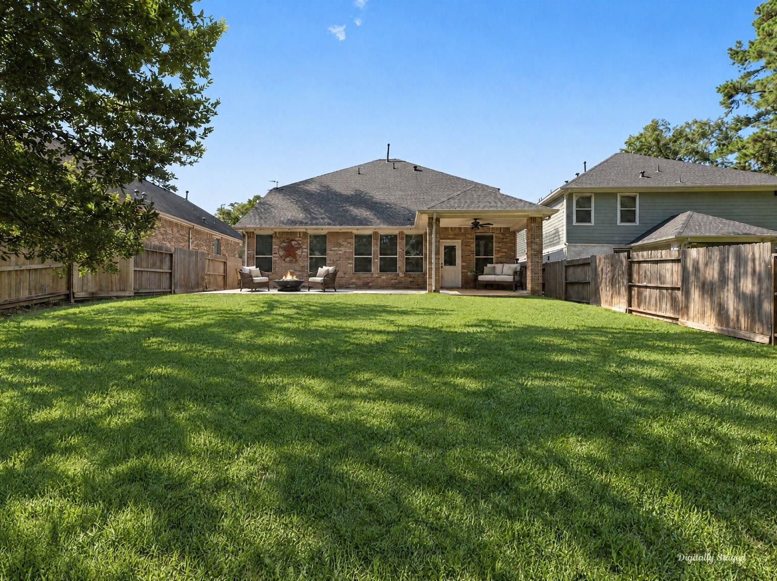 230 Elianne Lace Court, Conroe, TX 77318 Rear of the home showing a brick exterior, a covered patio, and a wide, level lawn. Full wood fencing and tall trees make the backyard feel open yet private.
This photo has been digitally staged to illustrate the possibilities of the homes aesthetic and potential design. Some furnishings and dcor shown are for visual inspiration.