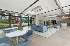230 Elianne Lace Court, Conroe, TX 77318 The architecturally stunning clubhouse features clean lines and large windows, housing multipurpose rooms for events, a fitness center, nd shaded outdoor seating areas perfect for gathering with neighbors.