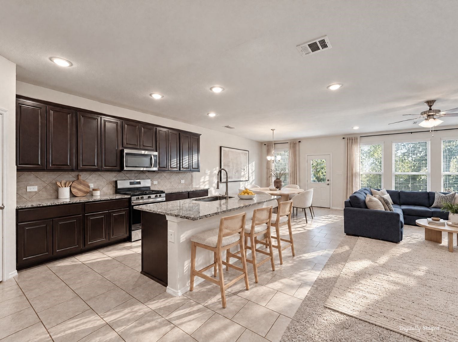 230 Elianne Lace Court, Conroe, TX 77318 Kitchen flowing openly into the dining and living spaces for a connected main floor. Dark cabinetry and granite counters contrast nicely with the light tile and carpet.
This photo has been digitally staged to illustrate the possibilities of the homes aesthetic and potential design. Some furnishings and dcor shown are for visual inspiration.