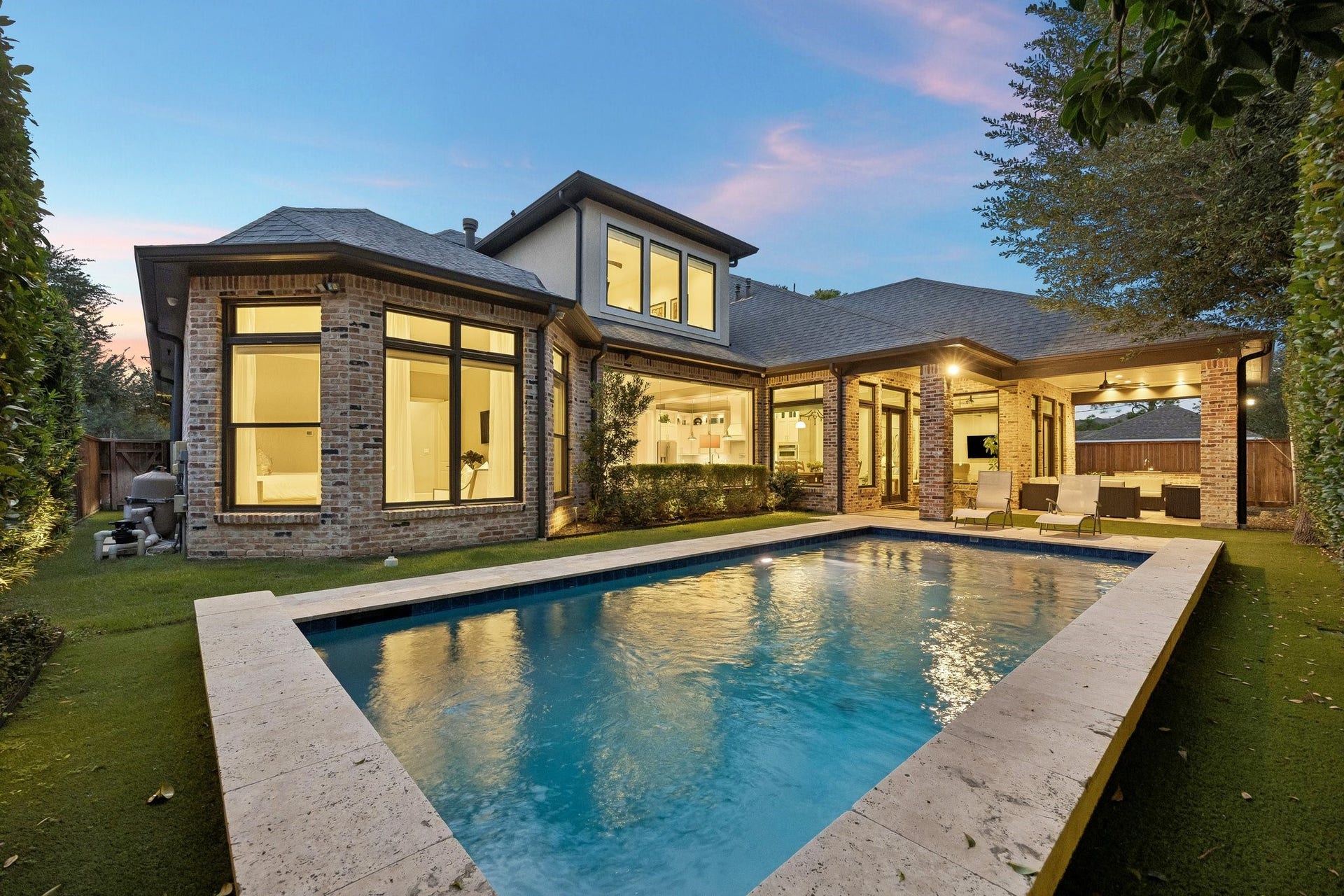 This spectacular resort-inspired salt-water pool serves as the centerpiece of an extraordinary private backyard retreat, beautifully blending contemporary luxury with timeless architectural elegance.