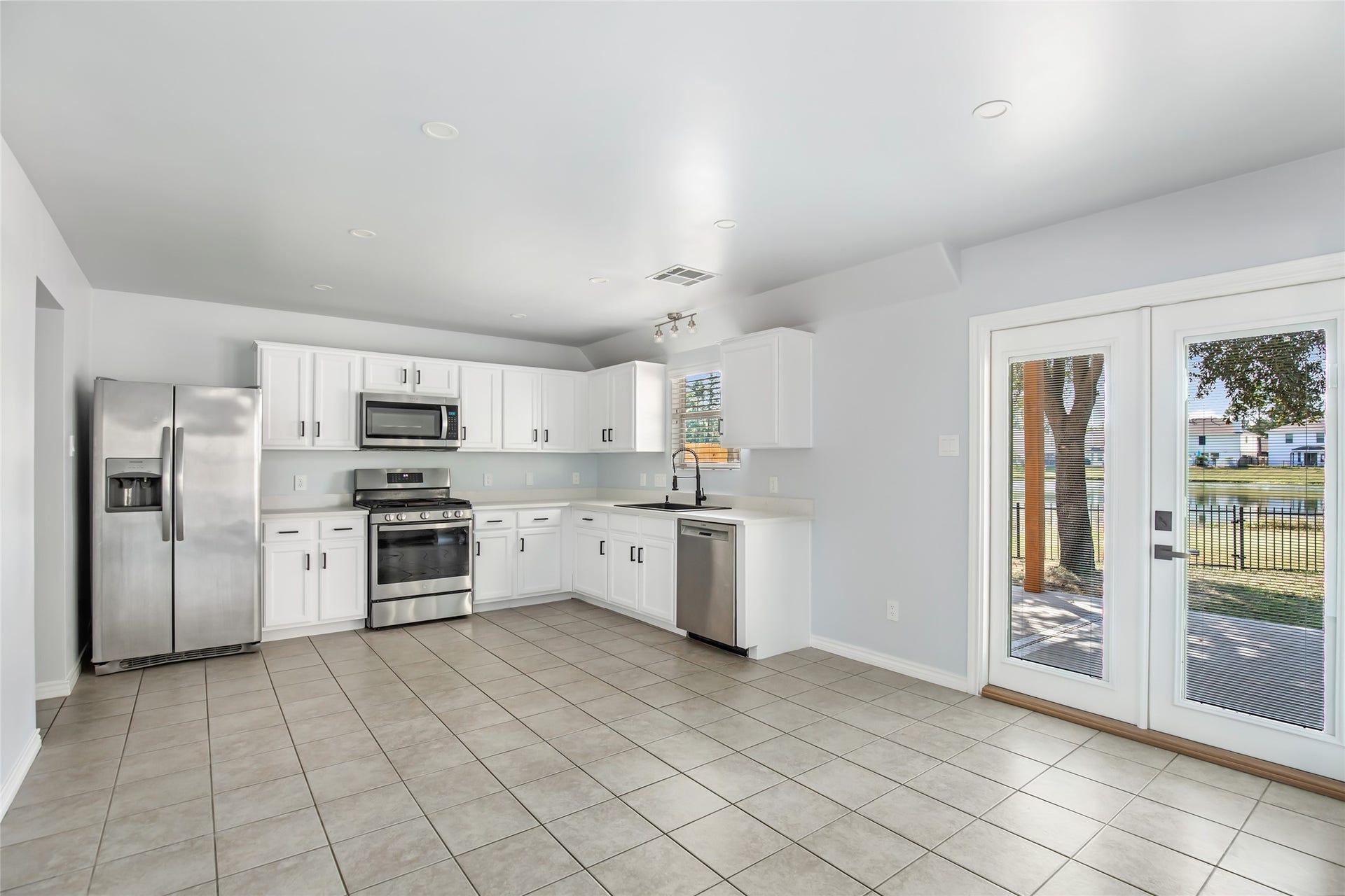 639 Trail Springs Court, Kingwood, TX 77339 Access to the large, covered patio overlook the pond
