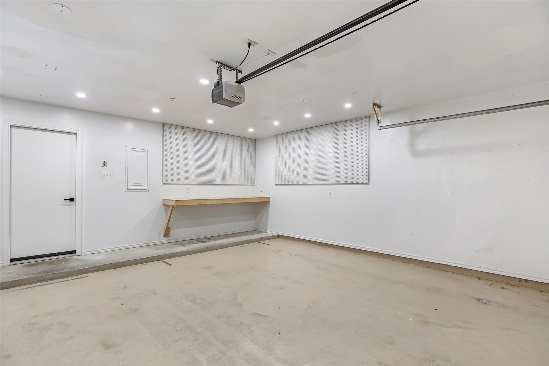 639 Trail Springs Court, Kingwood, TX 77339 Work bench area with recessed lighting & peg board in garage