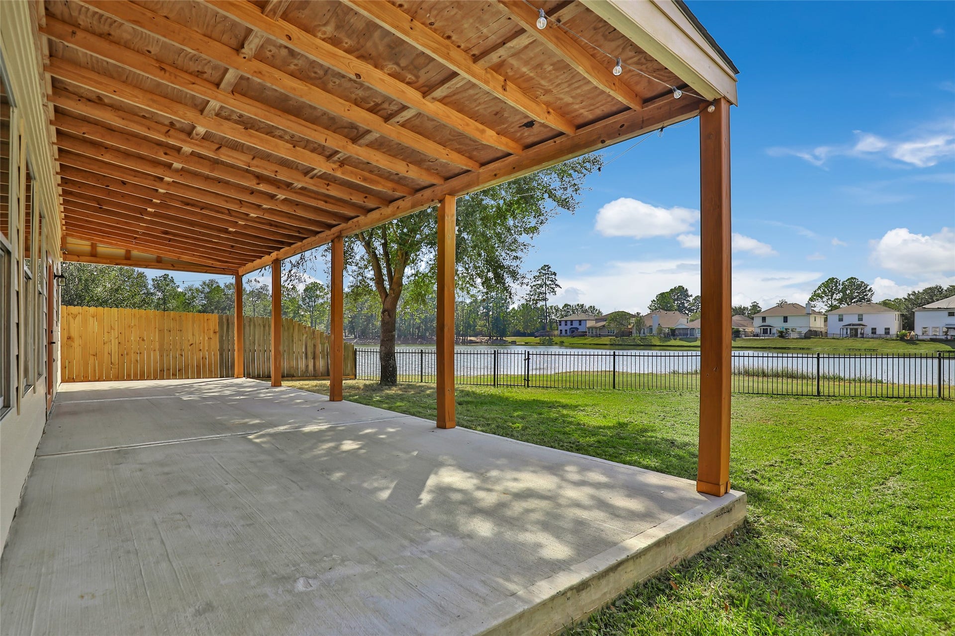 639 Trail Springs Court, Kingwood, TX 77339 Large, covered back patio with a relaxing view of the pond