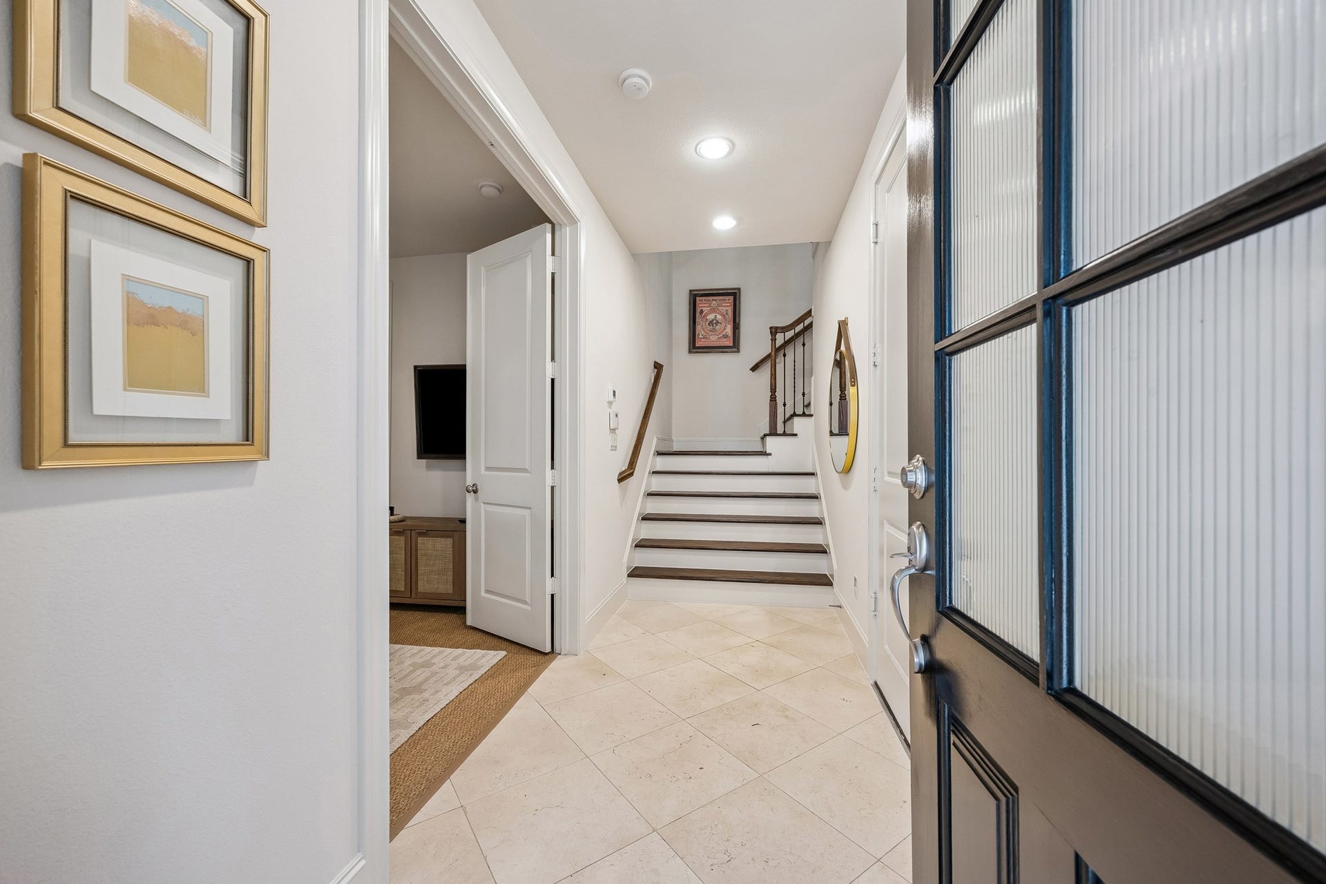 2721 Cohn Street, Houston, TX 77007 Welcoming entry opens to a bright foyer featuring stone flooring, crisp millwork & a beautiful staircase, offering a polished introduction to the homes thoughtfully designed interior.