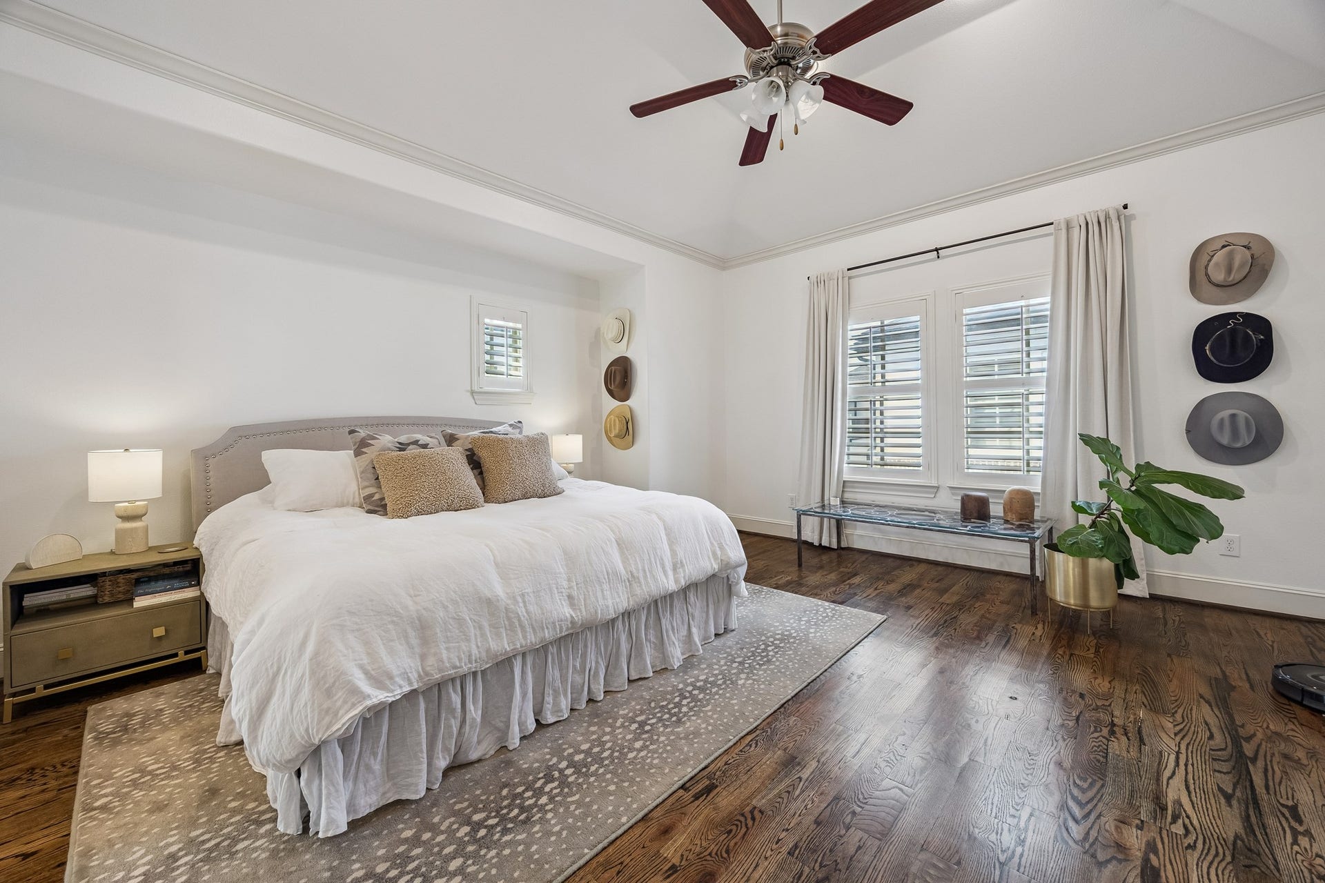 2721 Cohn Street, Houston, TX 77007 Spacious primary suite features rich wood floors, crown molding, a high ceiling w/ceiling fan & large windows bringing in natural light, creating an impressive retreat w/ room for a sitting area.