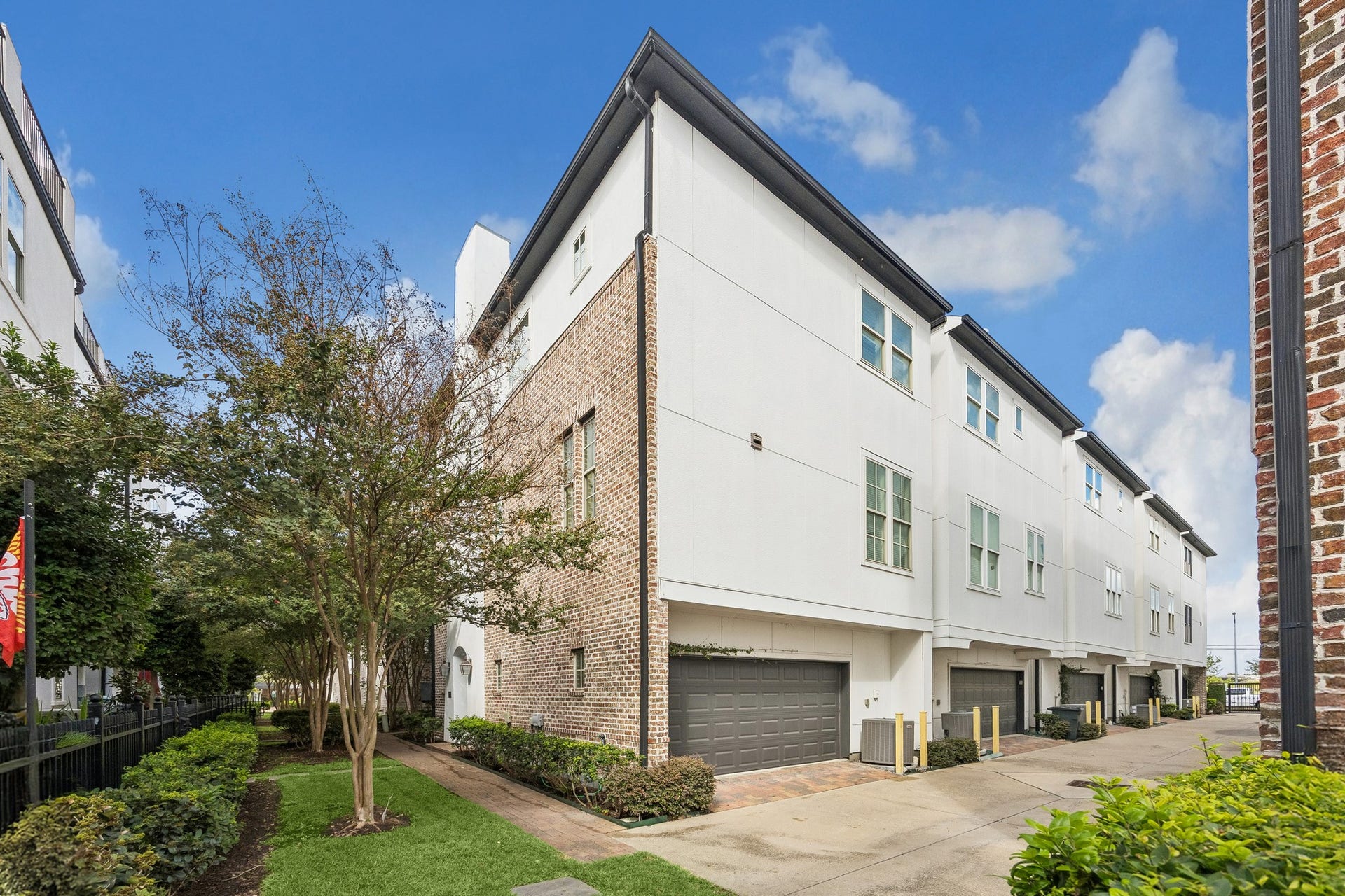 2721 Cohn Street, Houston, TX 77007 Rear view of the corner residence featuring an attached two-car garage & easy access within the gated community.