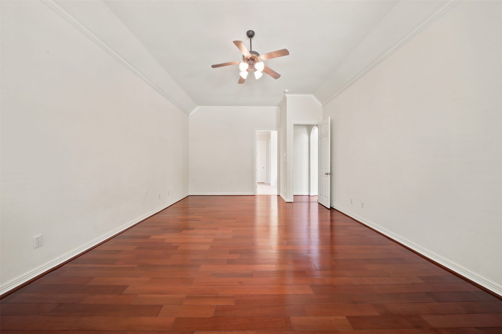 26306 Eden Point Court, Katy, TX 77494 Alternate primary bedroom view showing the generous room dimensions, hardwood flooring, ceiling fan, and access to the adjoining bath.