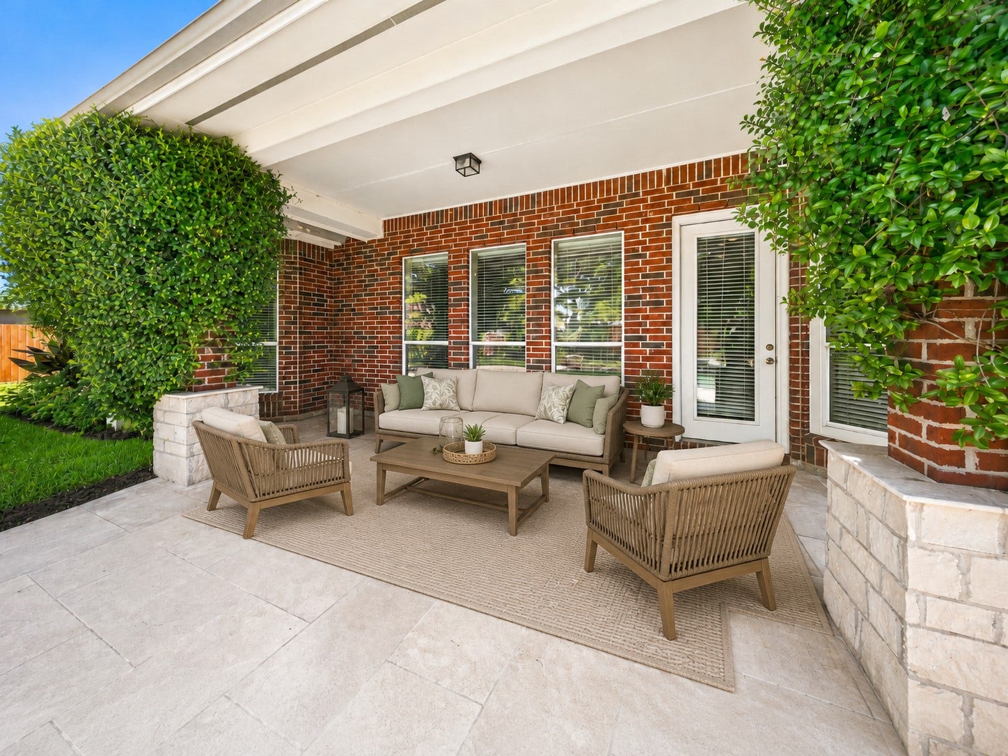 26306 Eden Point Court, Katy, TX 77494 Rear covered patio with tiled flooring, brick exterior, multiple windows, and direct backyard access.