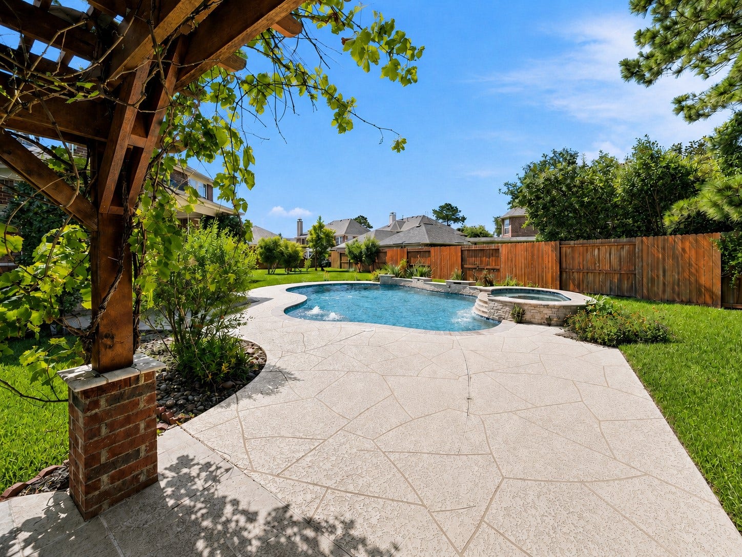 26306 Eden Point Court, Katy, TX 77494 Pool and spa framed by a broad patio, landscaped beds, and a fenced backyard.